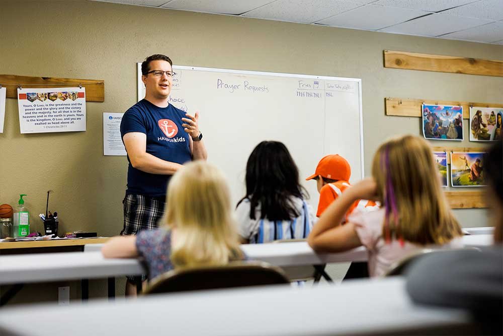 Teacher instructing children in a classroom setting