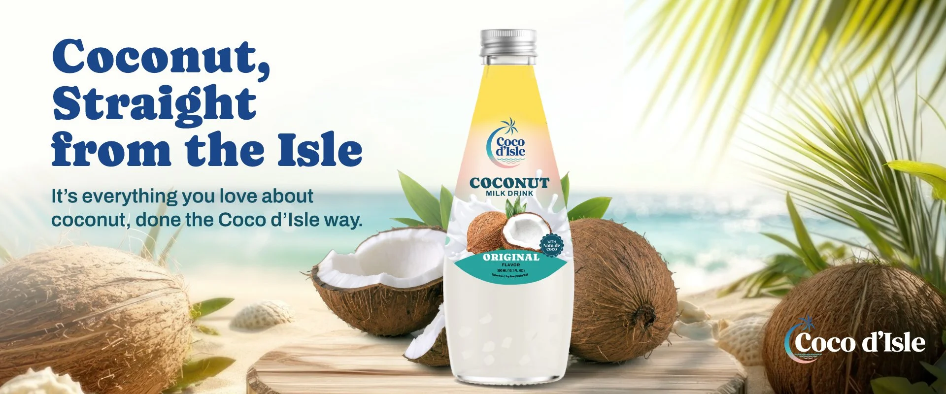 Coco d'Isle coconut milk drink on a beach with coconuts and palm leaves