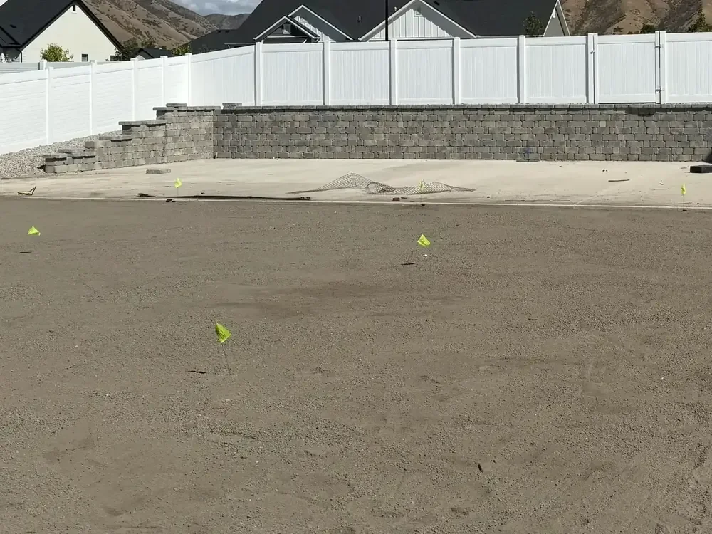 Paver block retaining wall under construction in a Utah yard