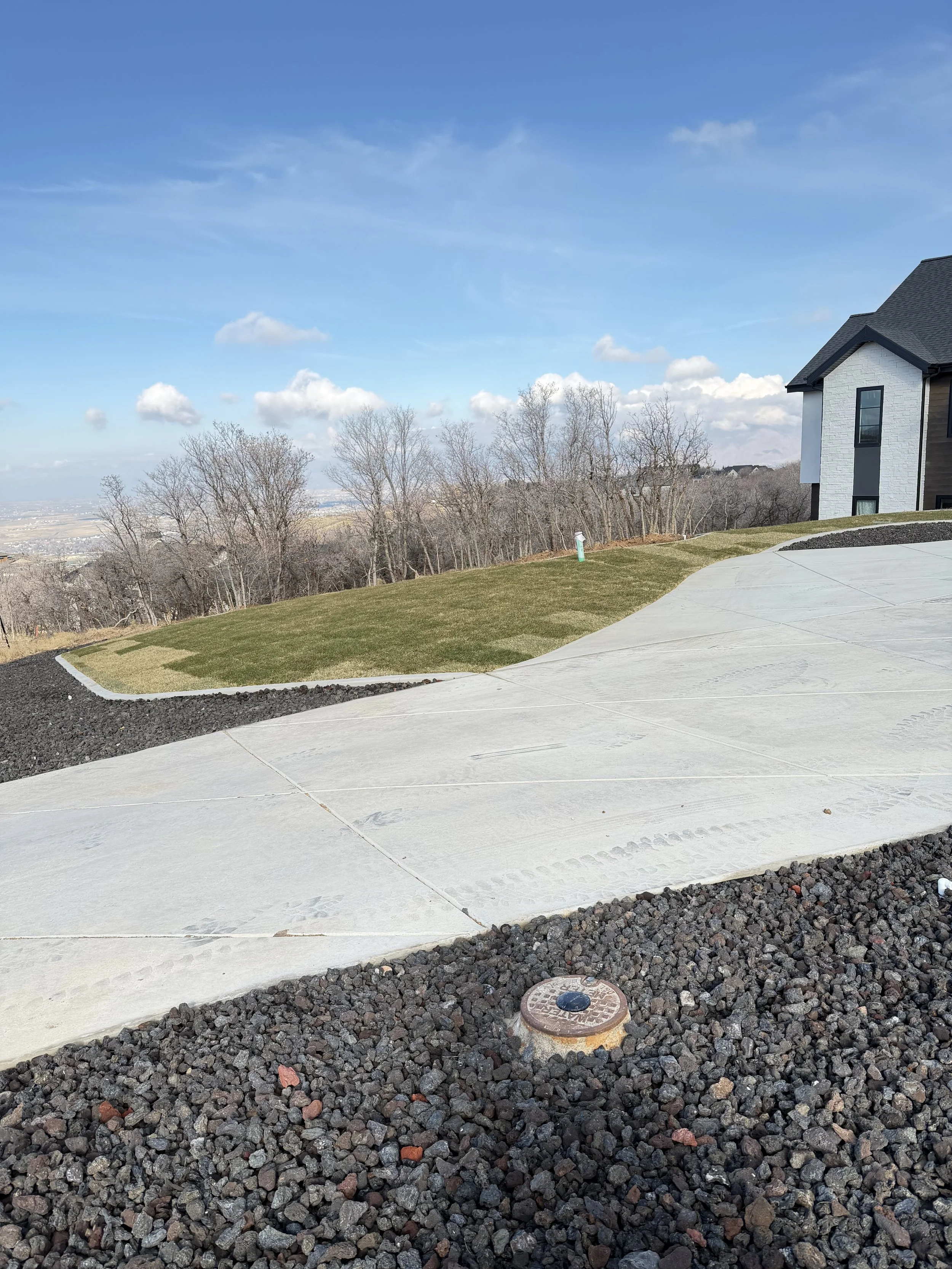 After photo of transformed front yard in Woodland Hills Utah with clean curbing and landscaping