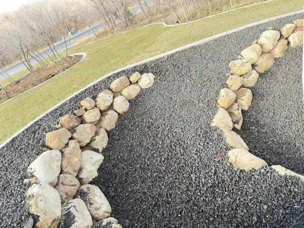 Rock bed with boulders and curbing in a Utah backyard
