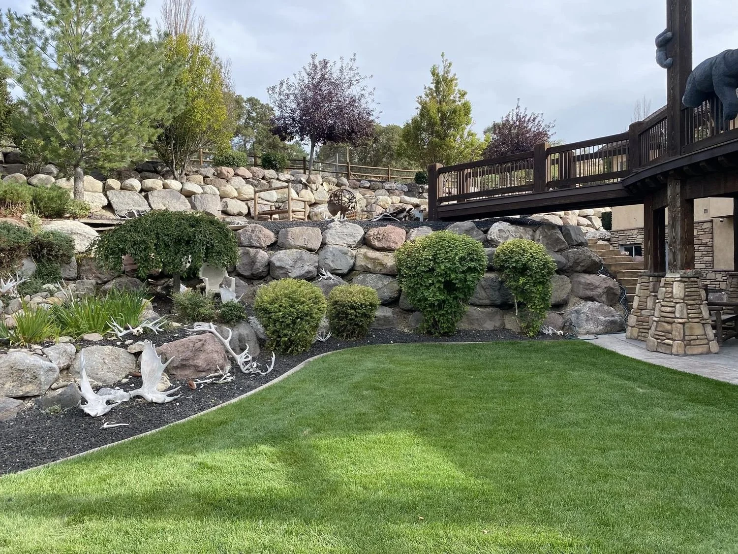 backyard in Lehi Utah with rock wall and sheds