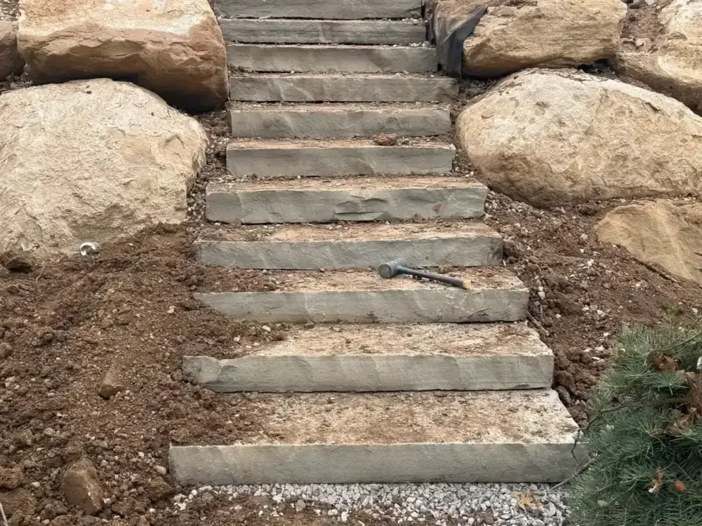 Natural stone stairs under construction between boulders in Utah