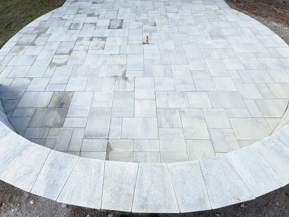 Circular gray paver patio with curved stone border in Utah