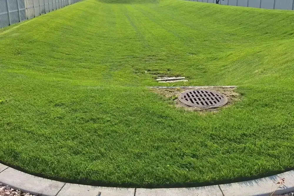 Neatly edged green lawn with drain grate in Lehi, Utah