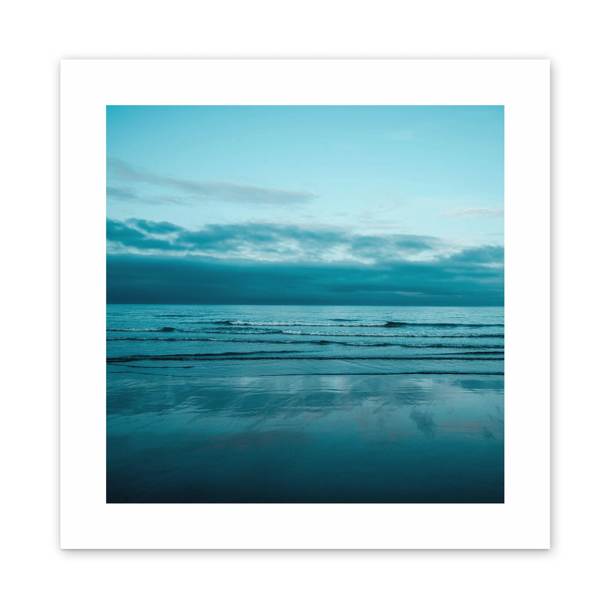 Sea Tranquility – Fine art photo of a still shoreline reflecting a moody blue sky by Anthony James.