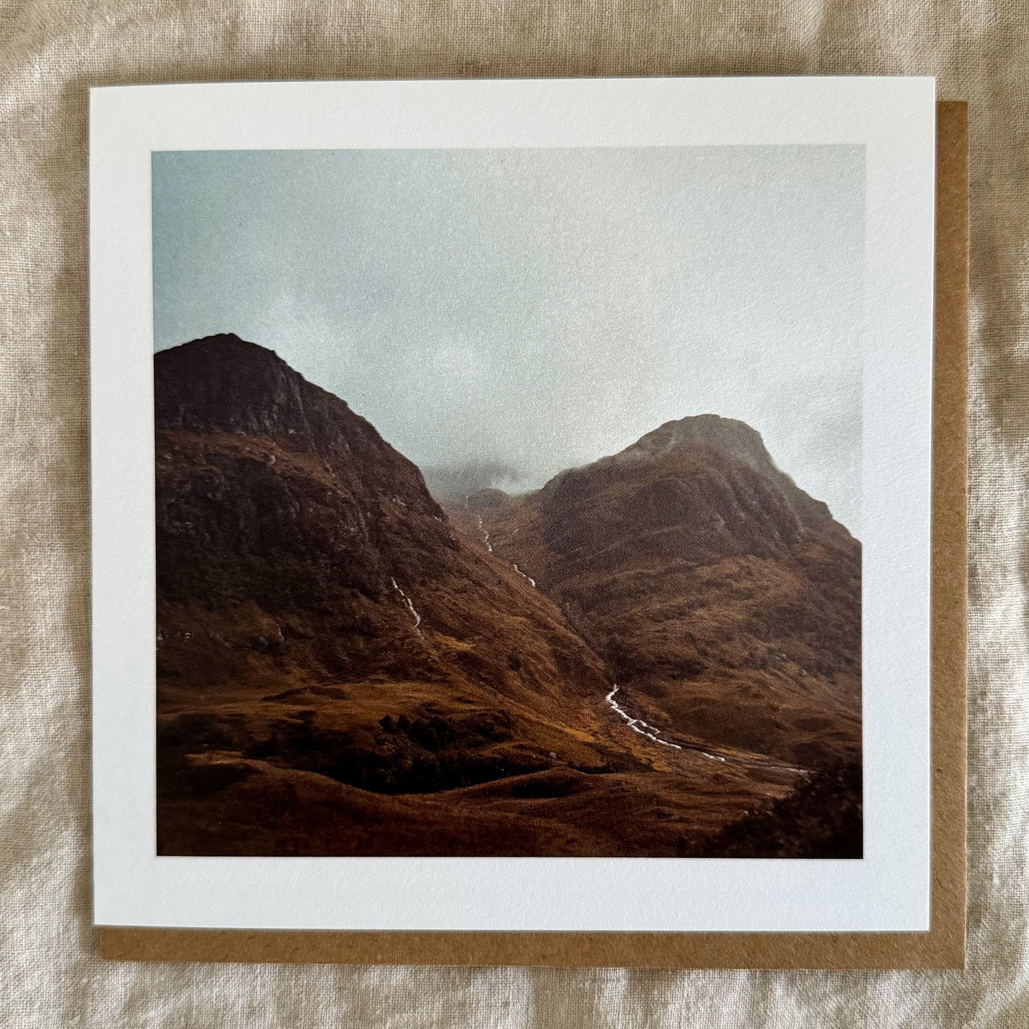 Luxury greeting card with earthy mountain terrain and gentle streams winding through the valley.