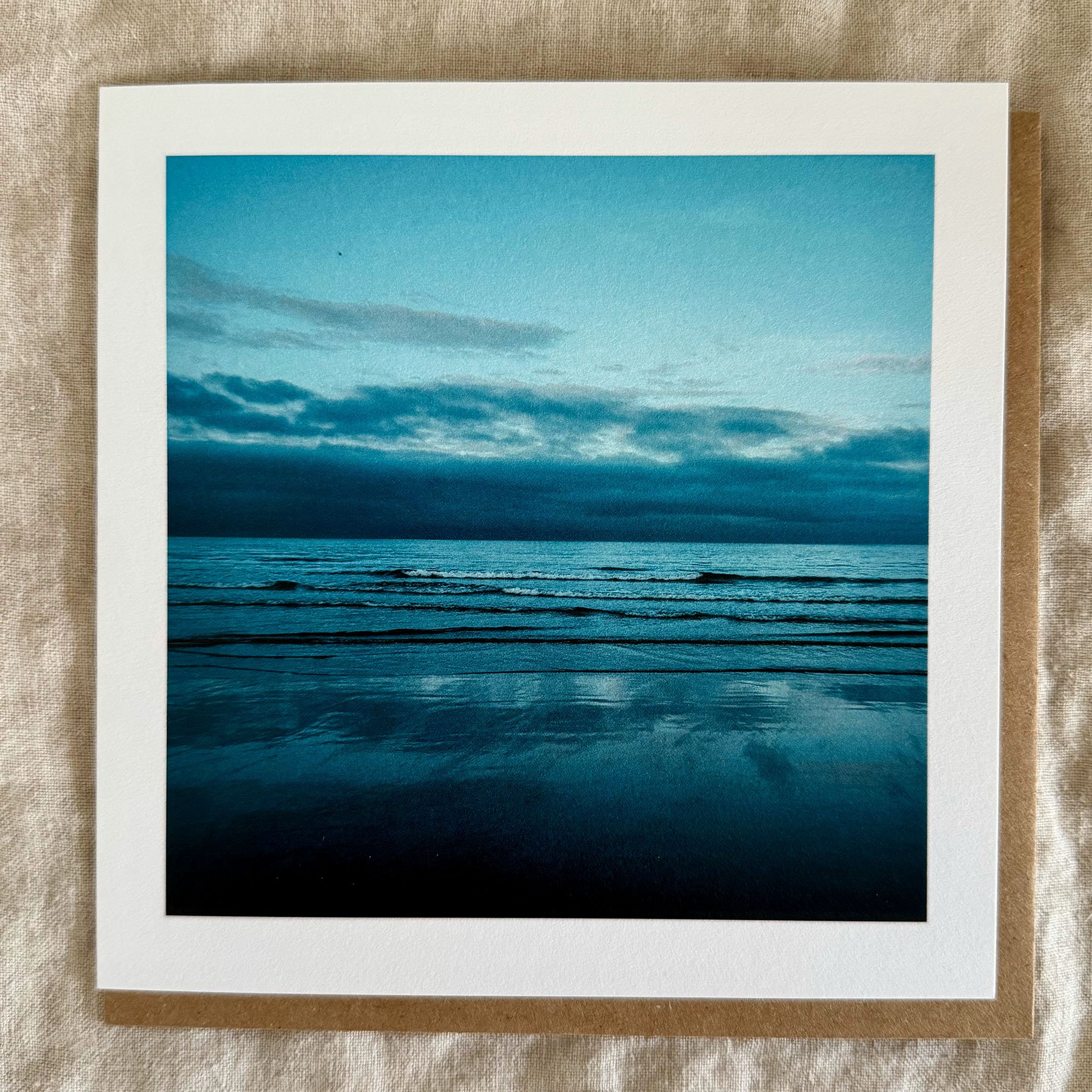 Luxury greeting card with peaceful waves and a blue-toned seascape under a soft sky.