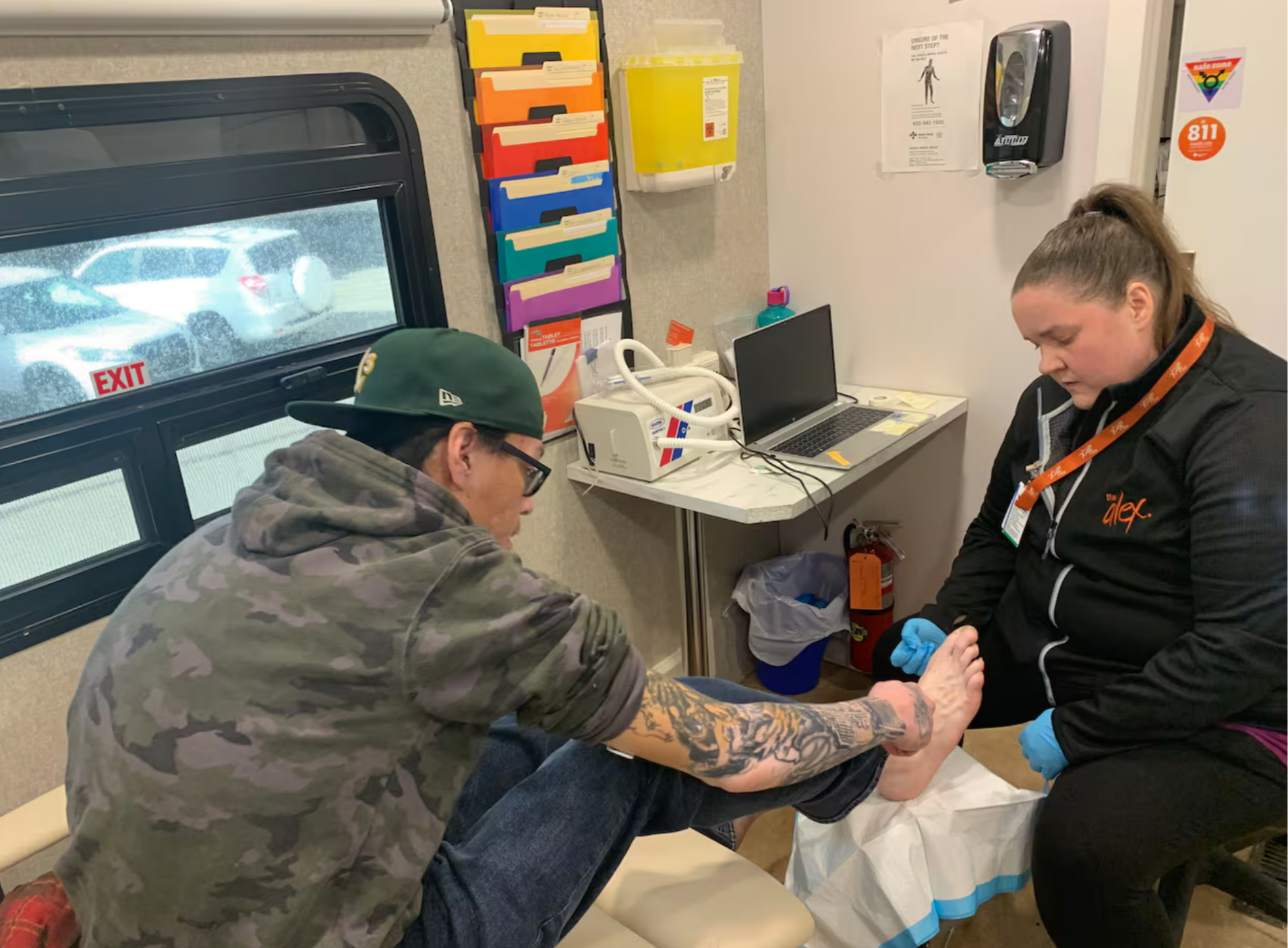Auger, left, discusses his foot ulcer with Dartnell.