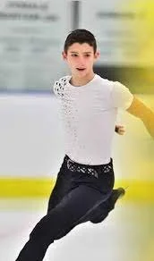 Young boy ice skating on an indoor rink