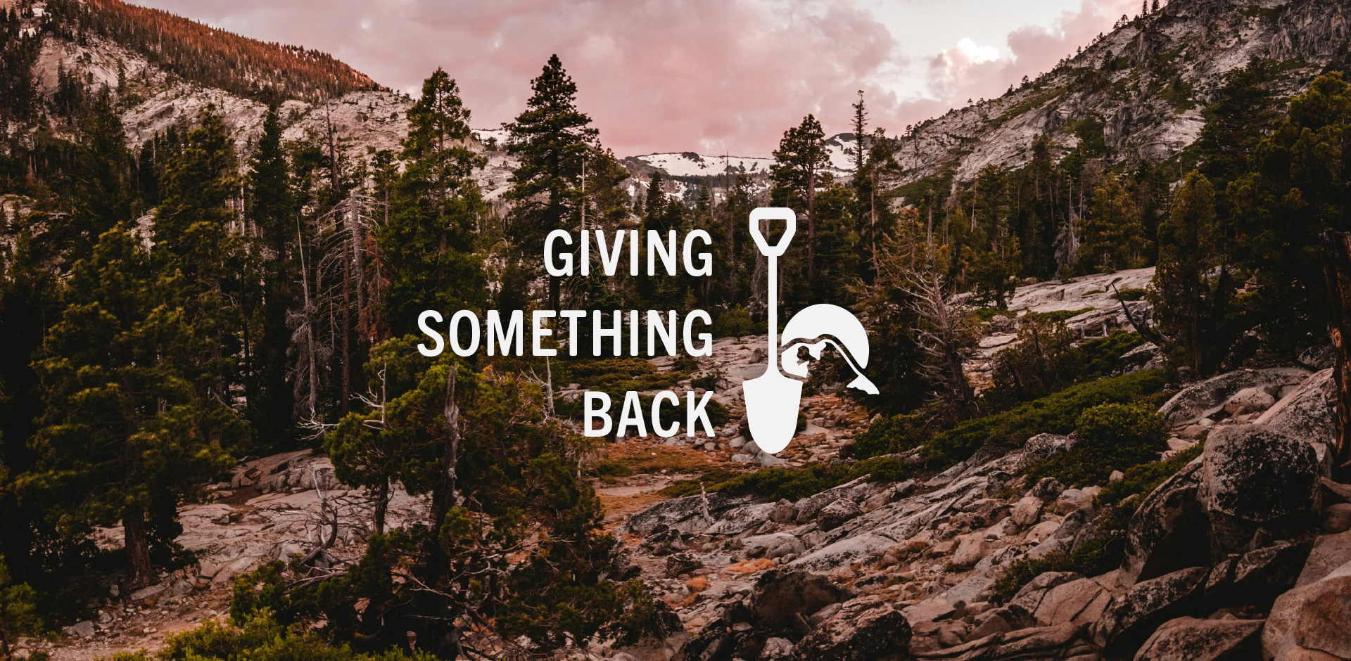 A mountainous landscape with trees, rocks, and a pink sky, overlaid with the white text 'Giving Something Back' and a graphic of a person digging with a shovel.