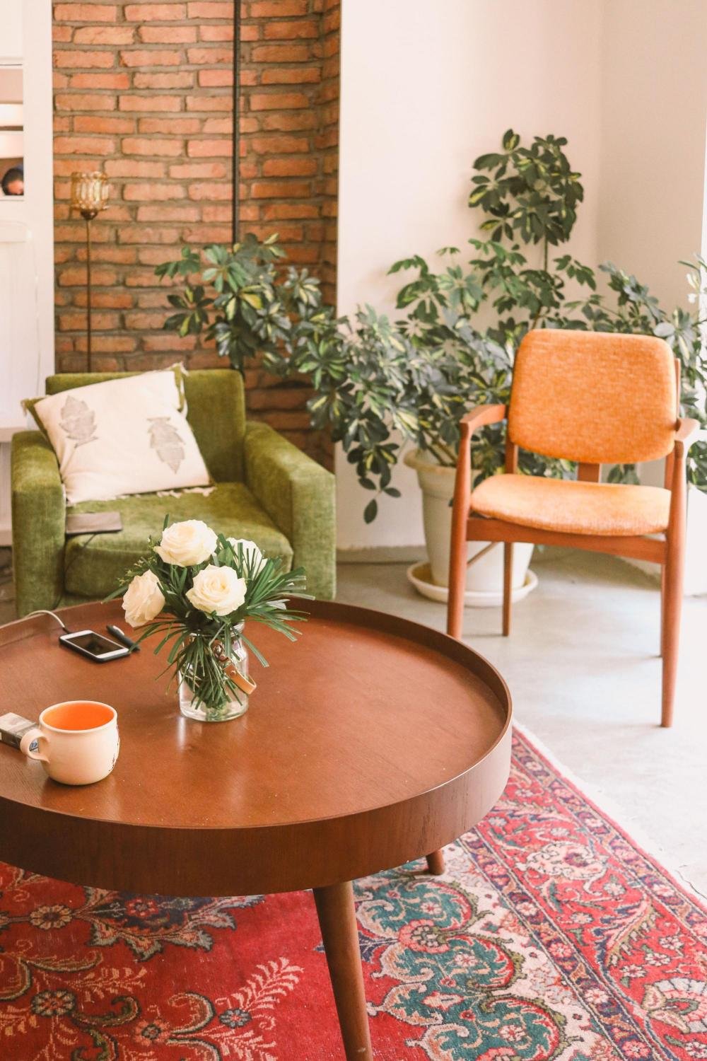 Sunlit therapy office with brick wall and coffee table, reflecting the warm, grounded space for midlife therapy in Seattle and Bellingham