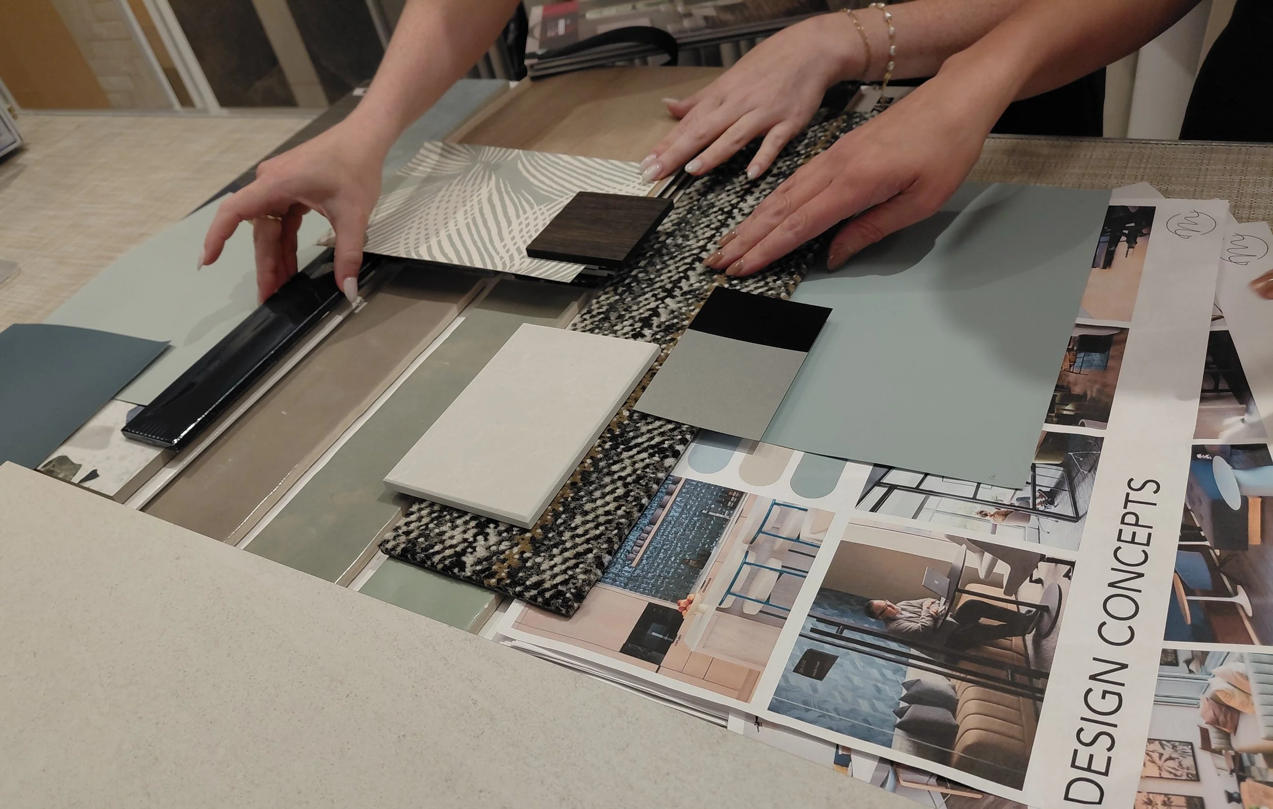 Design ideas and finish materials laid out on a table for interior design planning.