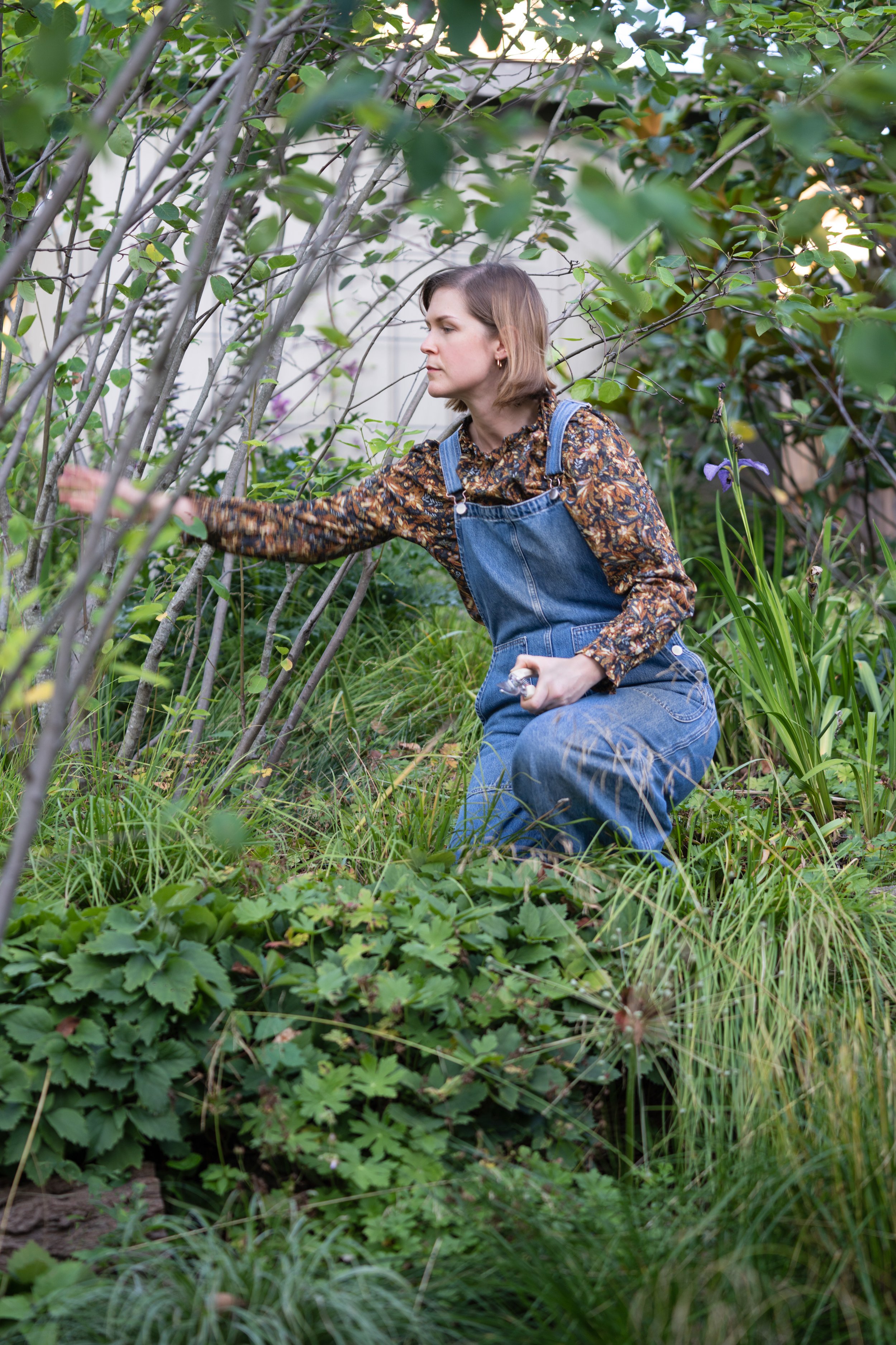 Designer and founder of Lloyd Landwright, Ashley Lloyd pruning in her garden