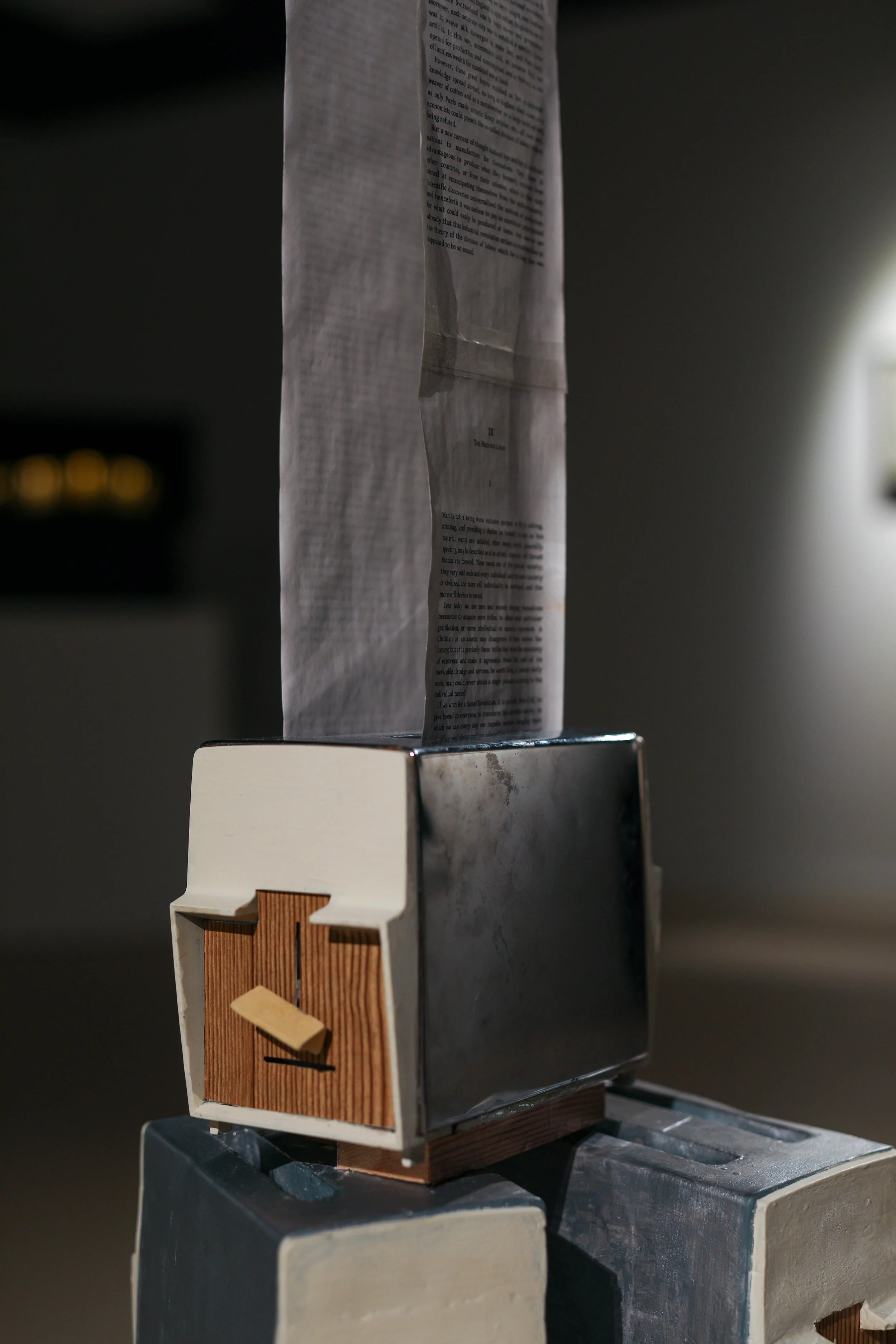 Detail: Becky Sellinger, La Conquête du pain, 2026, plaster, paint, mid century toaster, paper, faux wood drawer liner,  motor 

photo credit: Theo Cote