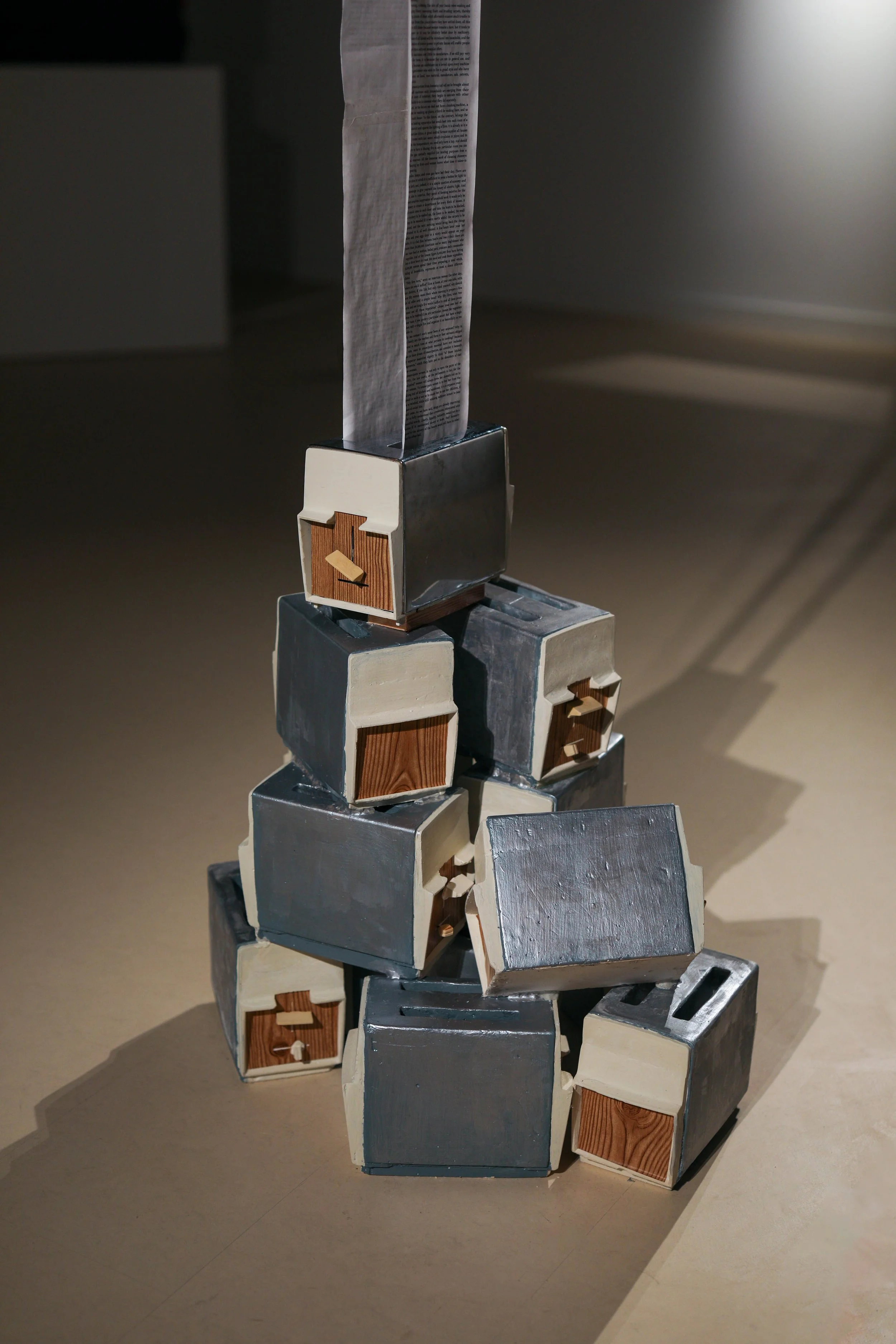 Becky Sellinger, La Conquête du pain, 2026, plaster, paint, mid century toaster, paper, faux wood drawer liner,  motor 

photo credit: Theo Cote