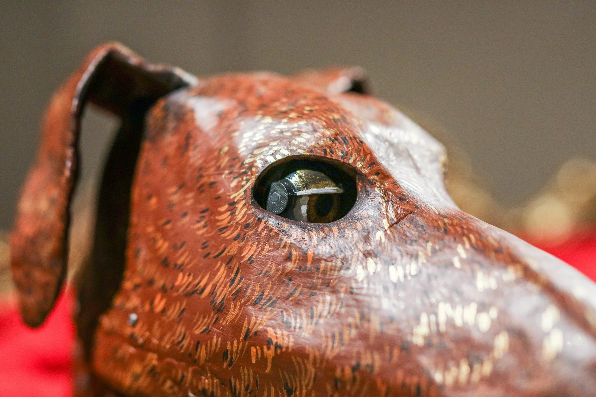 Detail: Becky Sellinger, Give A Dog a Good Name, 2026, Steel, foam, plastic, wood, rope, epoxy sculpt, servo motors, microprocessors, speaker, artist designed/printed PLA components, velvet, paint, 80 x 65 x 31

photo credit: Theo Cote