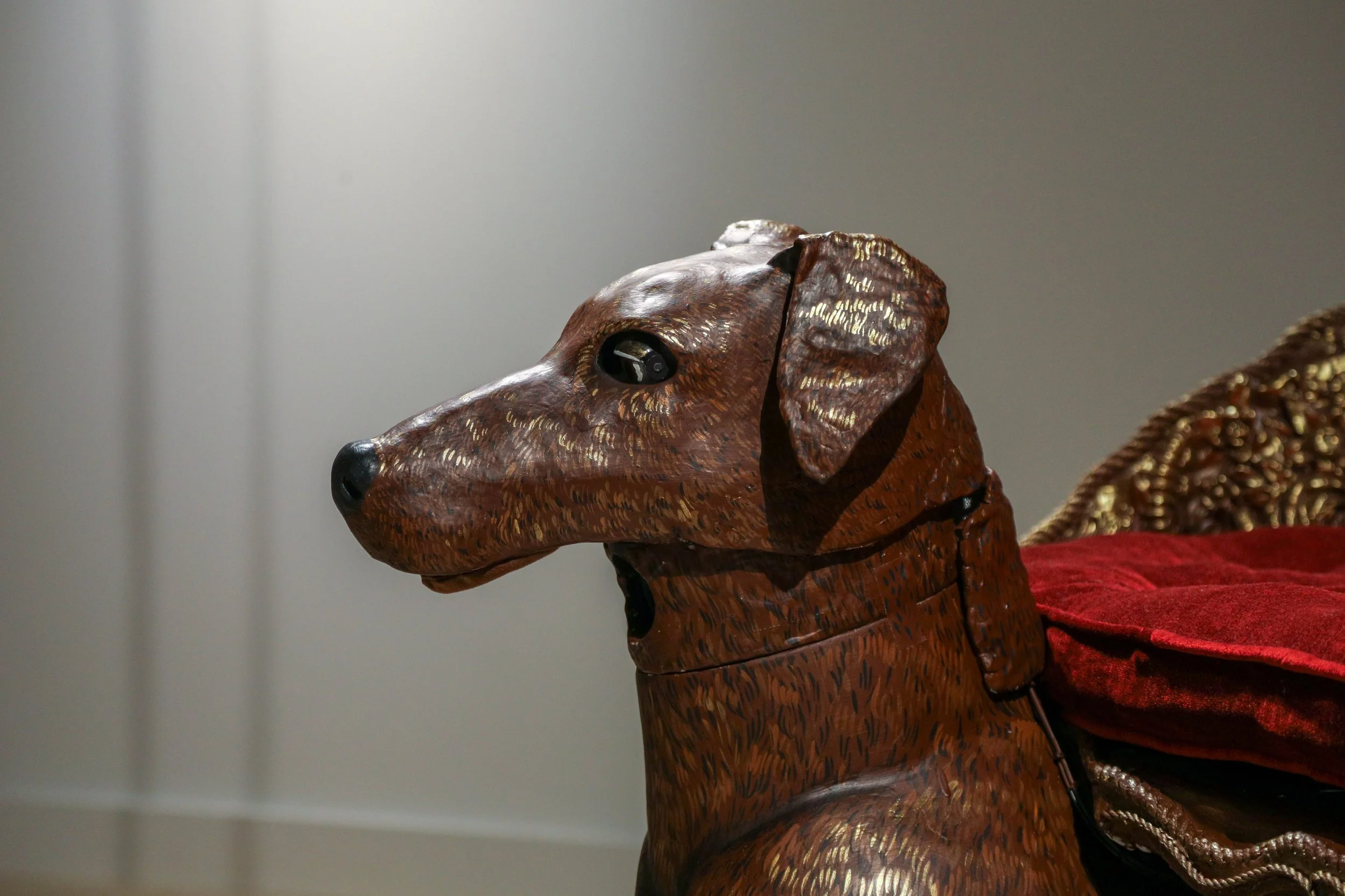 Detail: Becky Sellinger, Give A Dog a Good Name, 2026, Steel, foam, plastic, wood, rope, epoxy sculpt, servo motors, microprocessors, speaker, artist designed/printed PLA components, velvet, paint, 80 x 65 x 31

photo credit: Theo Cote