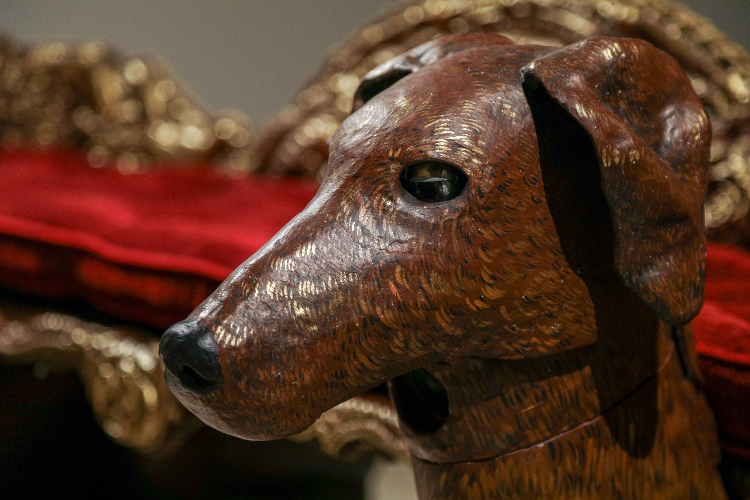 Detail: Becky Sellinger, Give A Dog a Good Name, 2026, Steel, foam, plastic, wood, rope, epoxy sculpt, servo motors, microprocessors, speaker, artist designed/printed PLA components, velvet, paint, 80 x 65 x 31

photo credit: Theo Cote