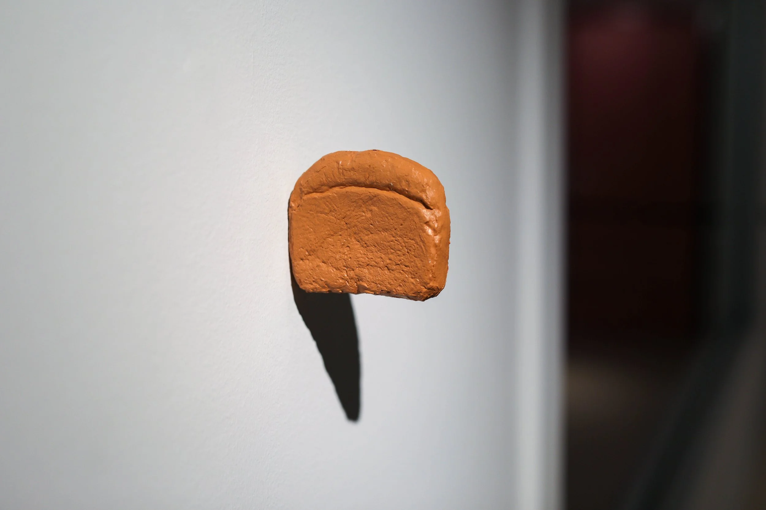 Becky Sellinger, Heel, 2026, bread, durhams rock hard putty, acrylic paint, 4 x 3.5 x .75
