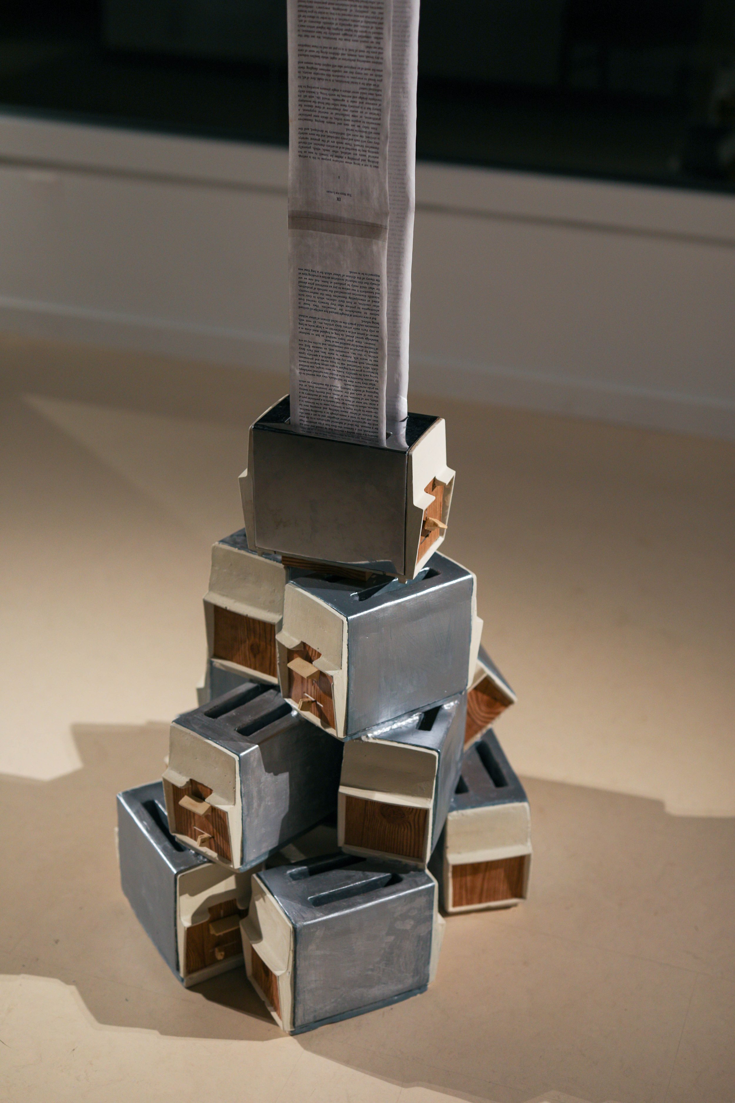 Detail: Becky Sellinger, La Conquête du pain, 2026, plaster, paint, mid century toaster, paper, faux wood drawer liner,  motor 

photo credit: Theo Cote