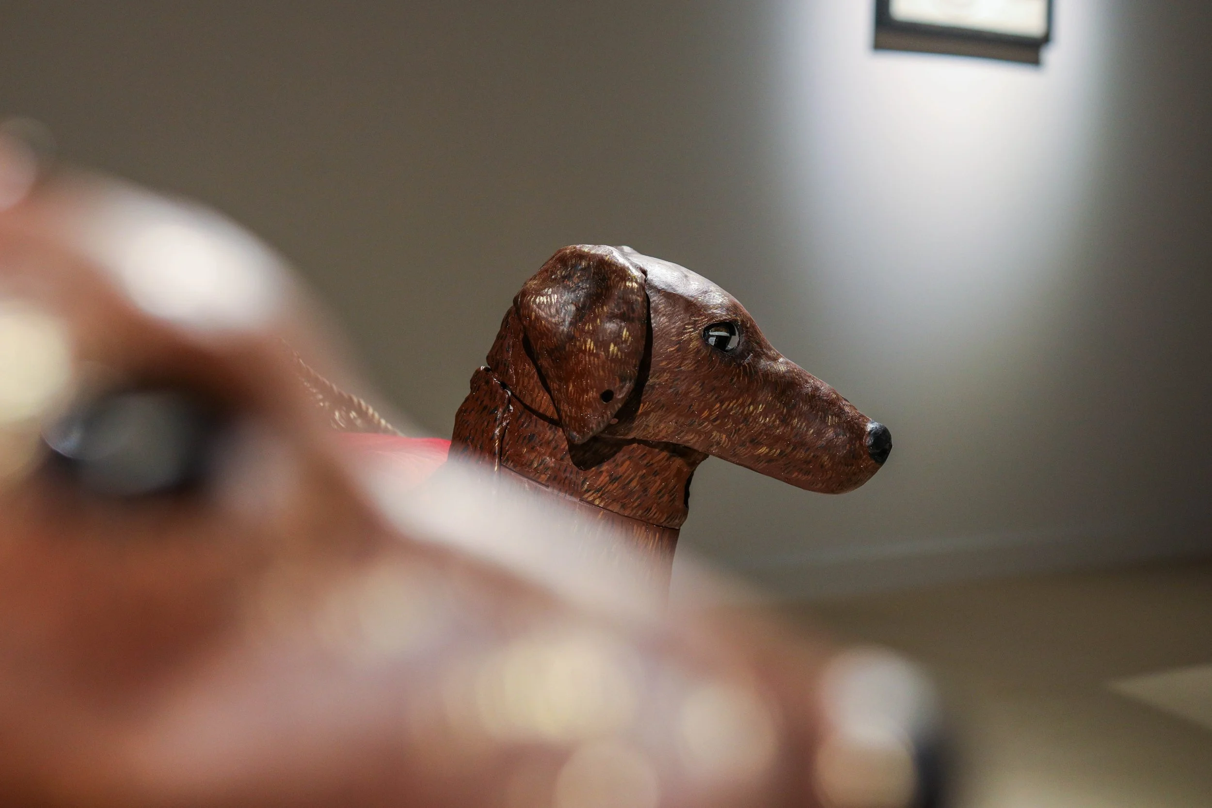 Detail: Becky Sellinger, Give A Dog a Good Name, 2026, Steel, foam, plastic, wood, rope, epoxy sculpt, servo motors, microprocessors, speaker, artist designed/printed PLA components, velvet, paint, 80 x 65 x 31

photo credit: Theo Cote