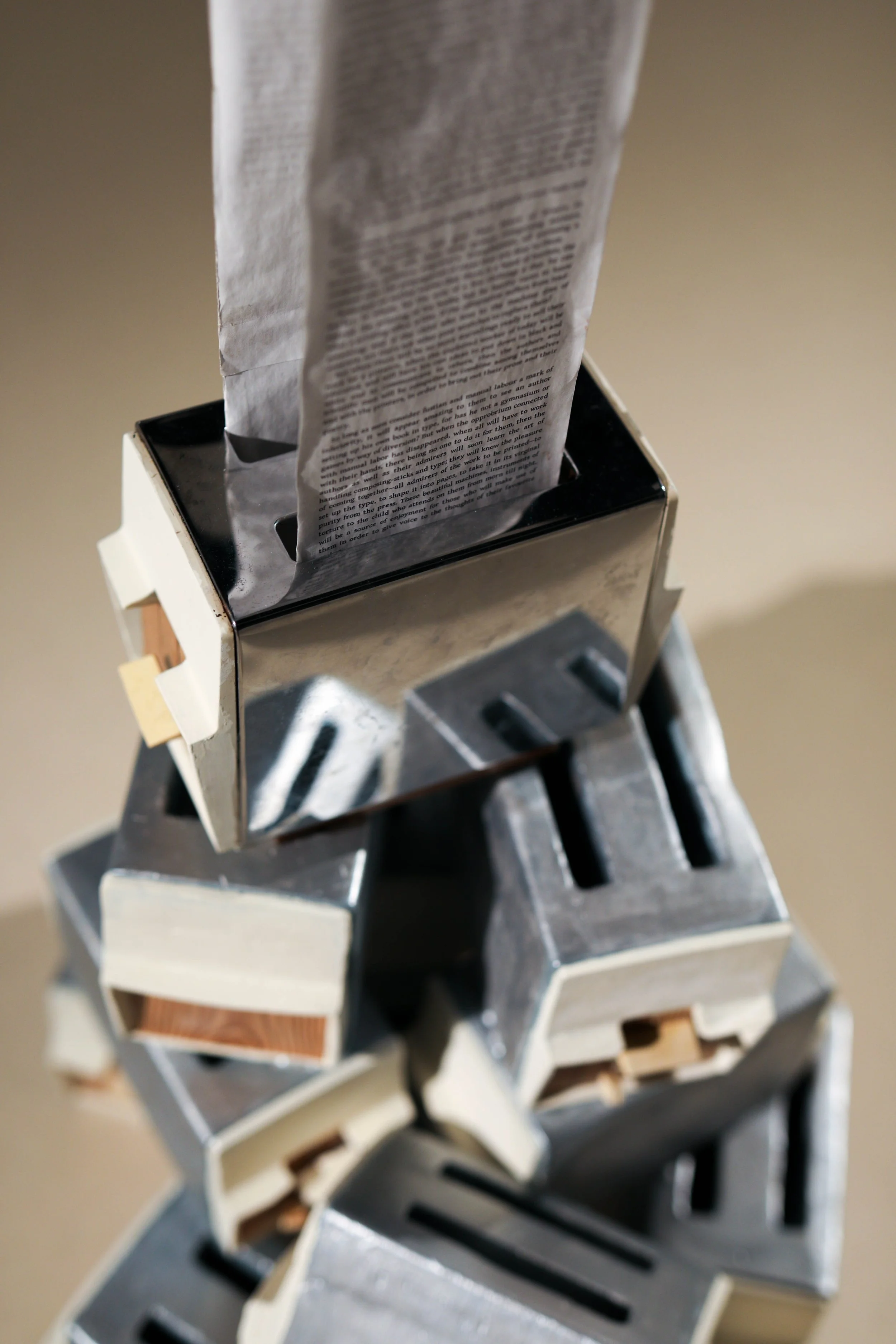Detail: Becky Sellinger, La Conquête du pain, 2026, plaster, paint, mid century toaster, paper, faux wood drawer liner, motor 

photo credit: Theo Cote