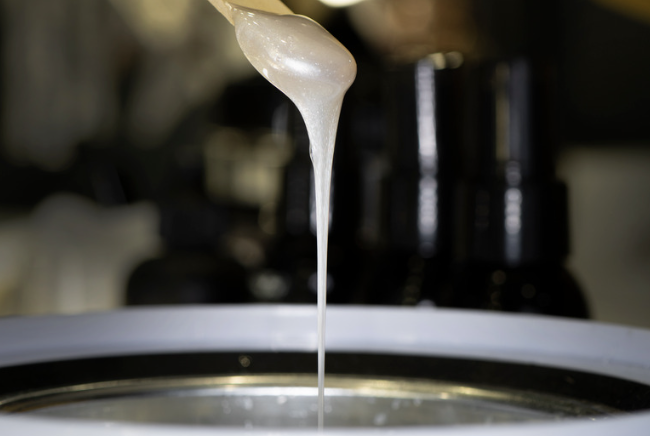 Close-up of melted body wax poured over a hot surface.
