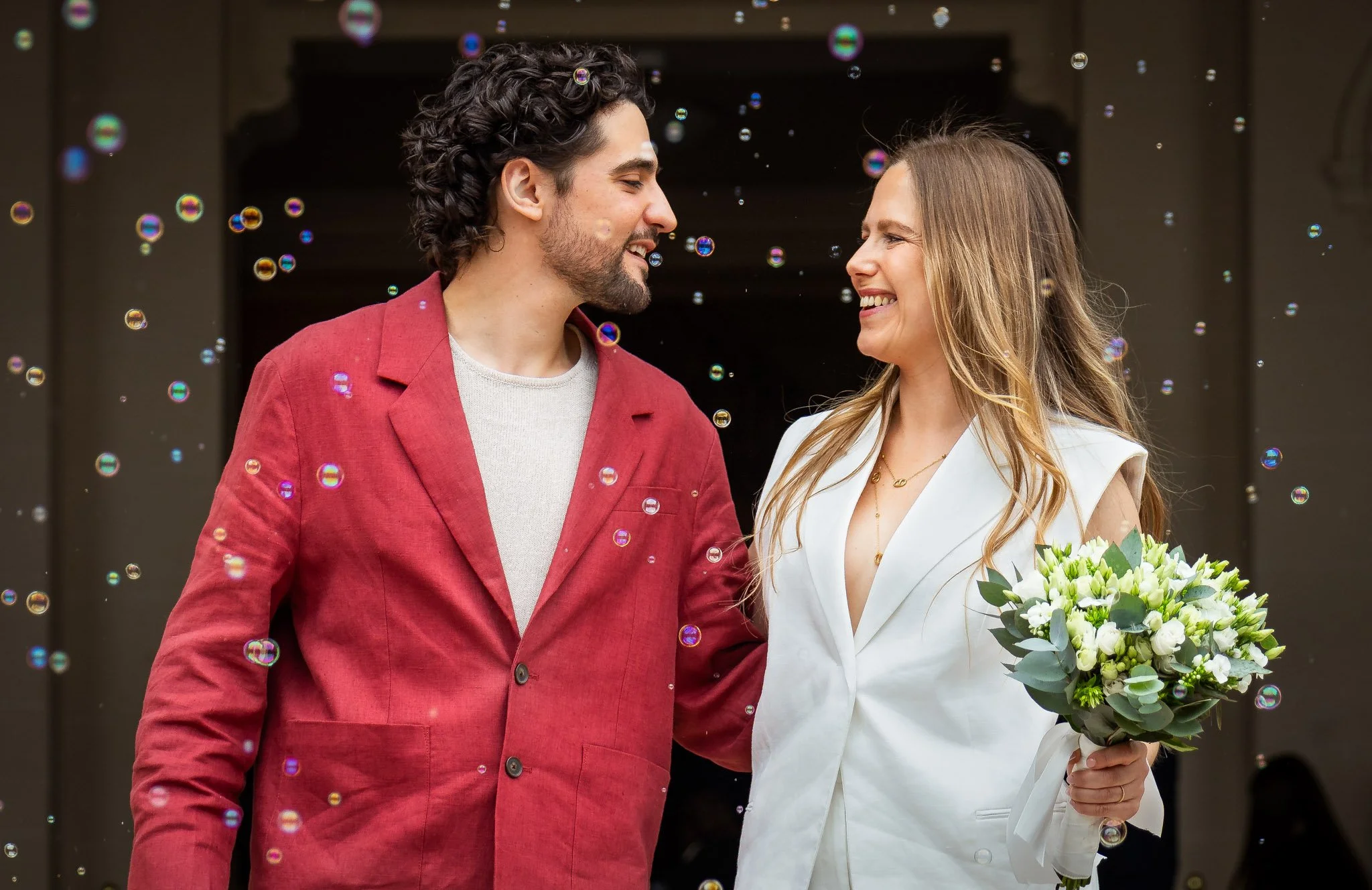 Mariés sortant de la mairie bouquet à la main et bulles