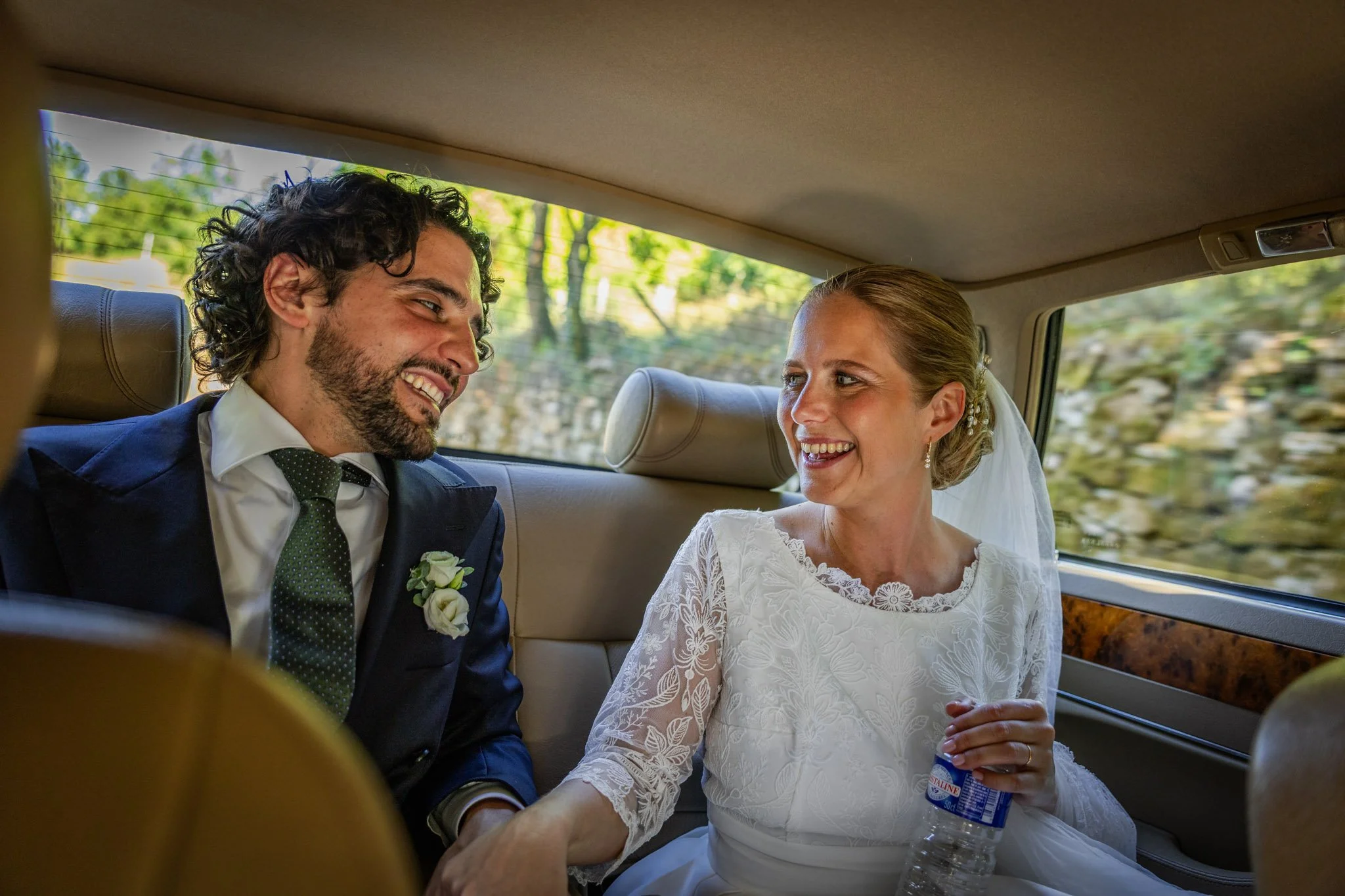 Mariés qui se regardent et se sourient dans la voiture