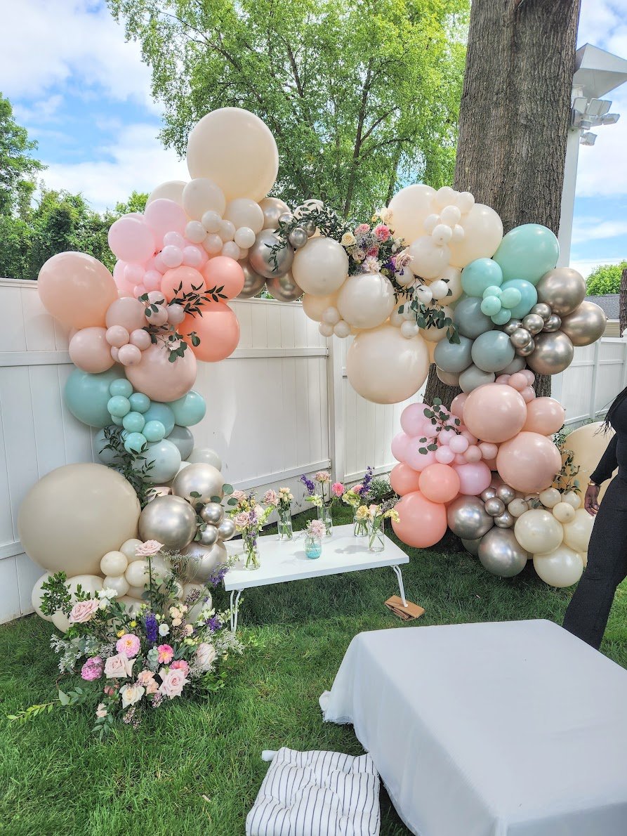 Balloon arch setup outside backyard party