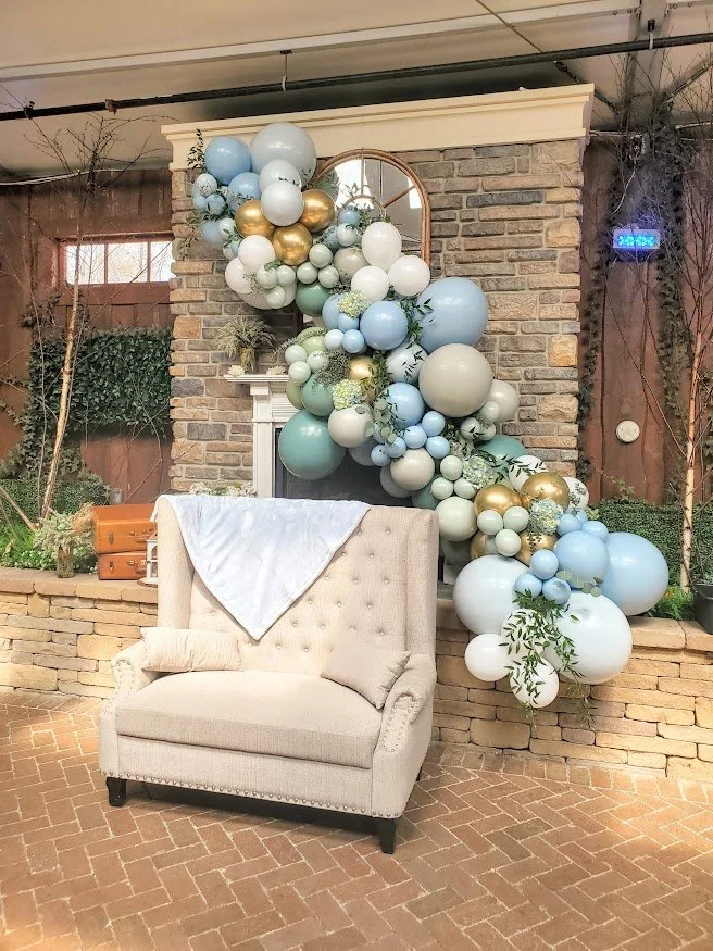 Balloon Garland installed on venue fireplace backdrop