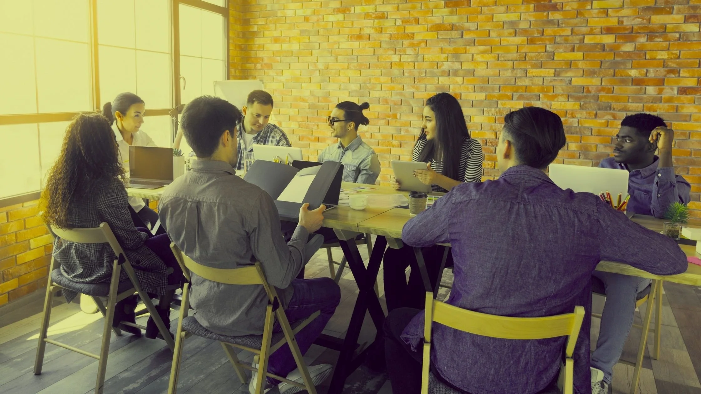 Marketing team meeting around a table discussing strategy and planning.
