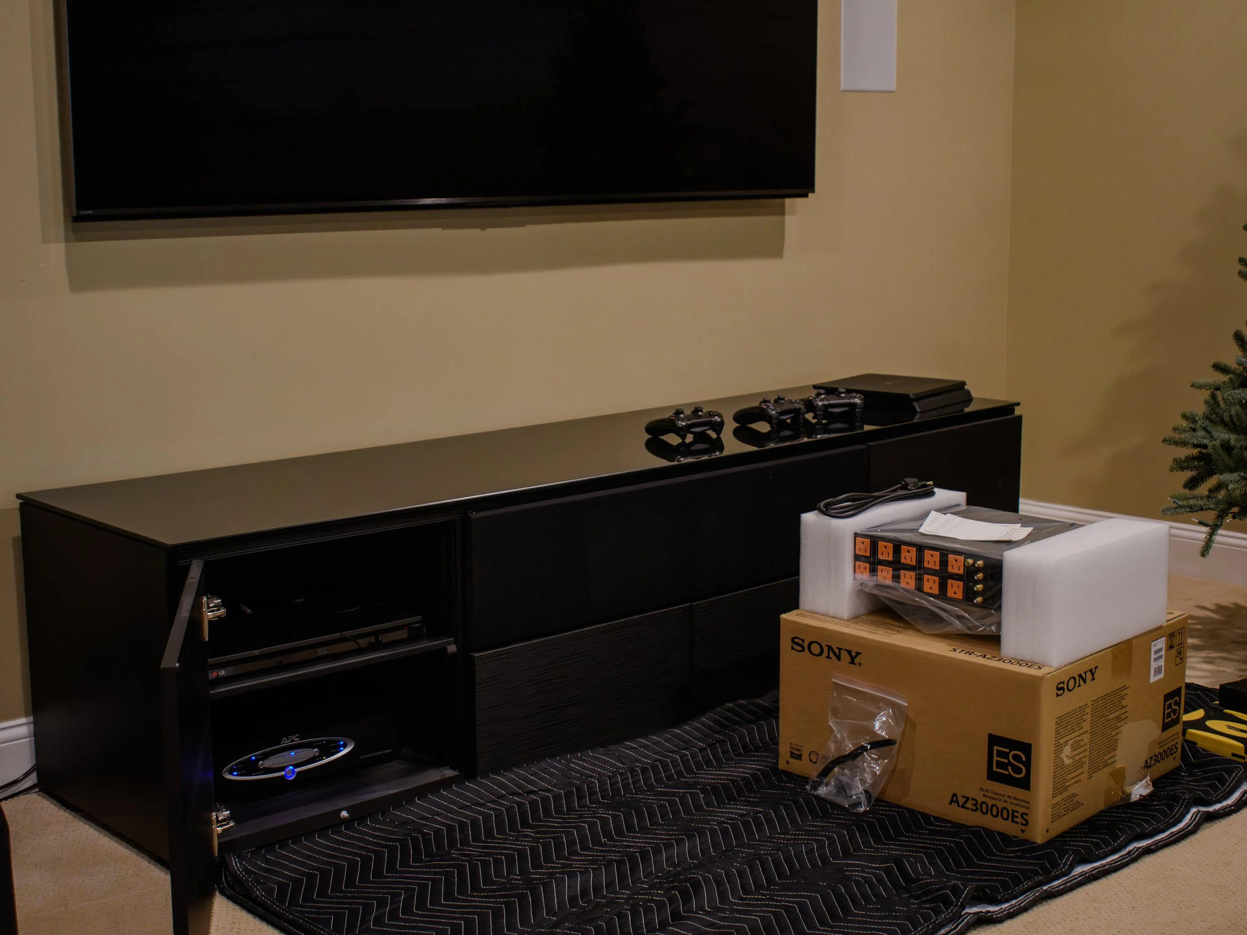 Living room with black entertainment center, ready for new Power and Audio Video Receiver upgrades.