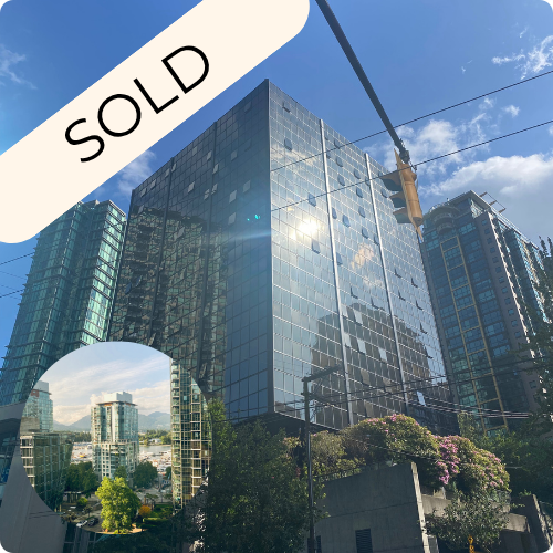 A tall modern glass office building reflecting the blue sky and nearby buildings, with a traffic light and wires in the foreground, and a "SOLD" overlay.
