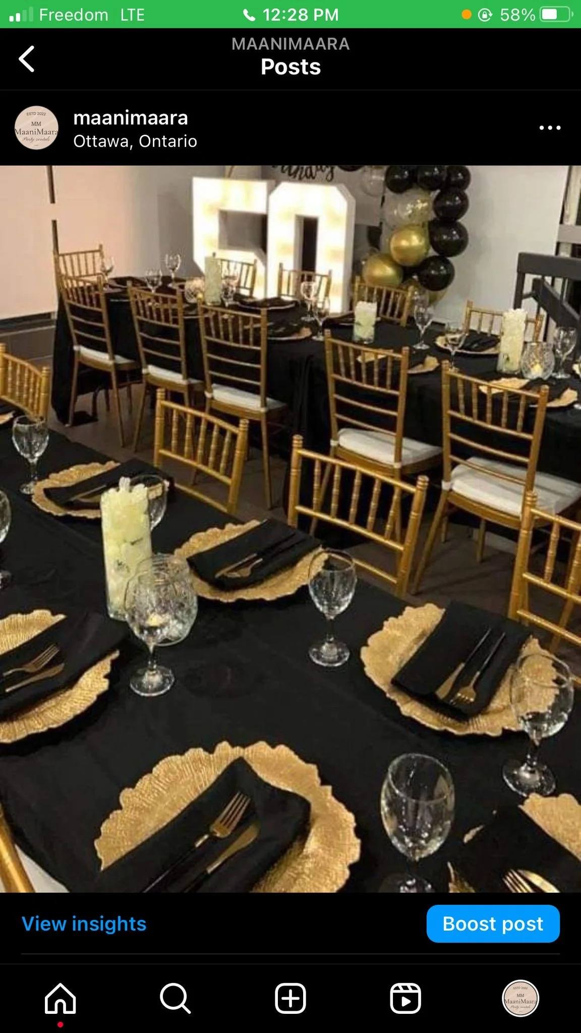 A banquet table decorated for a celebration with black tablecloths, gold placemats, black napkins, and glassware. Gold chairs are around the table, and a large illuminated number 30 and black, gold, and clear balloons are in the background.