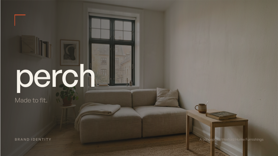 Minimalist living room with beige sofa, wooden side table, potted plant, window, and simple wall decor.