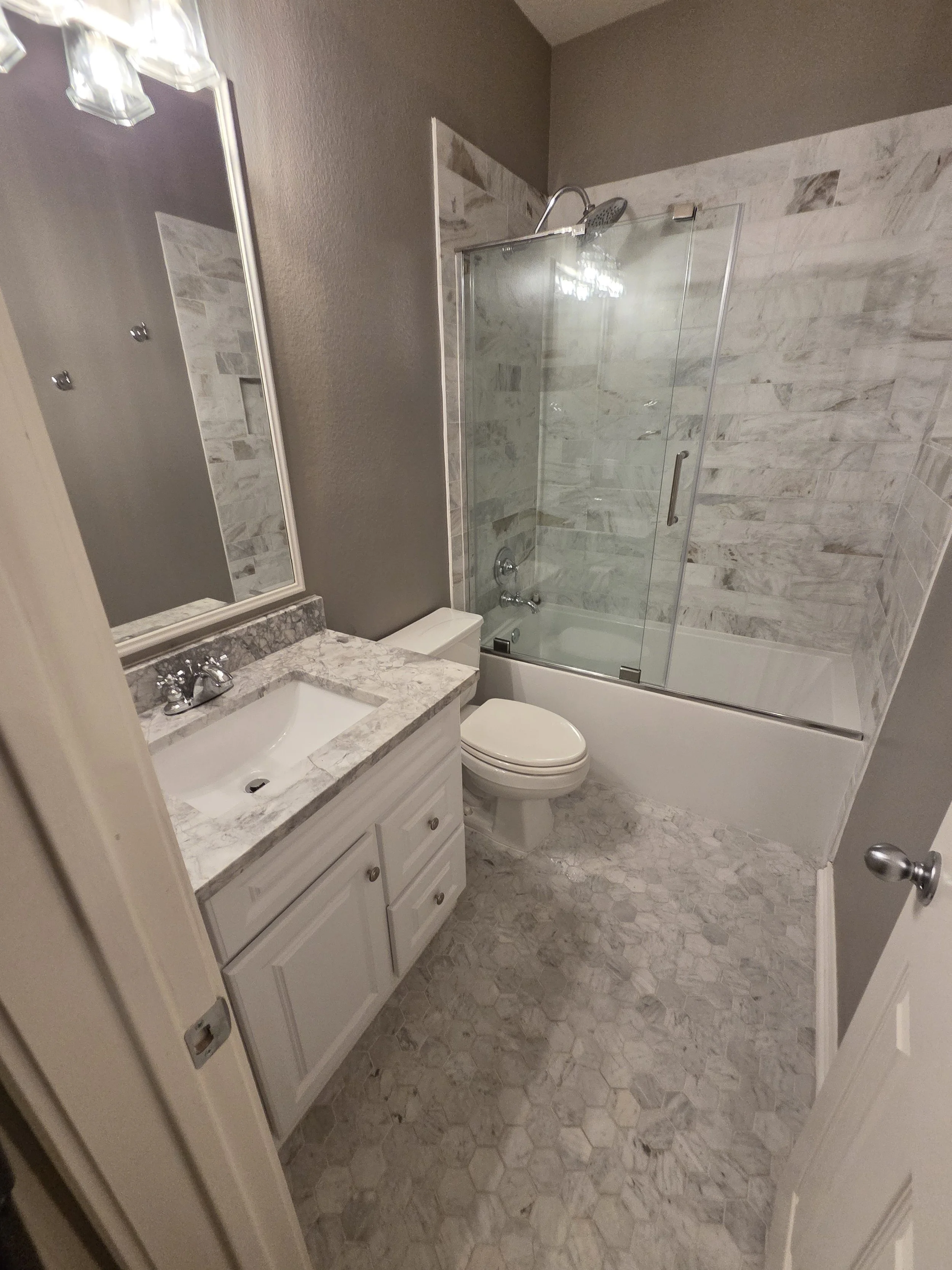 beautiful white marble countertops and shower tile in an austin area home