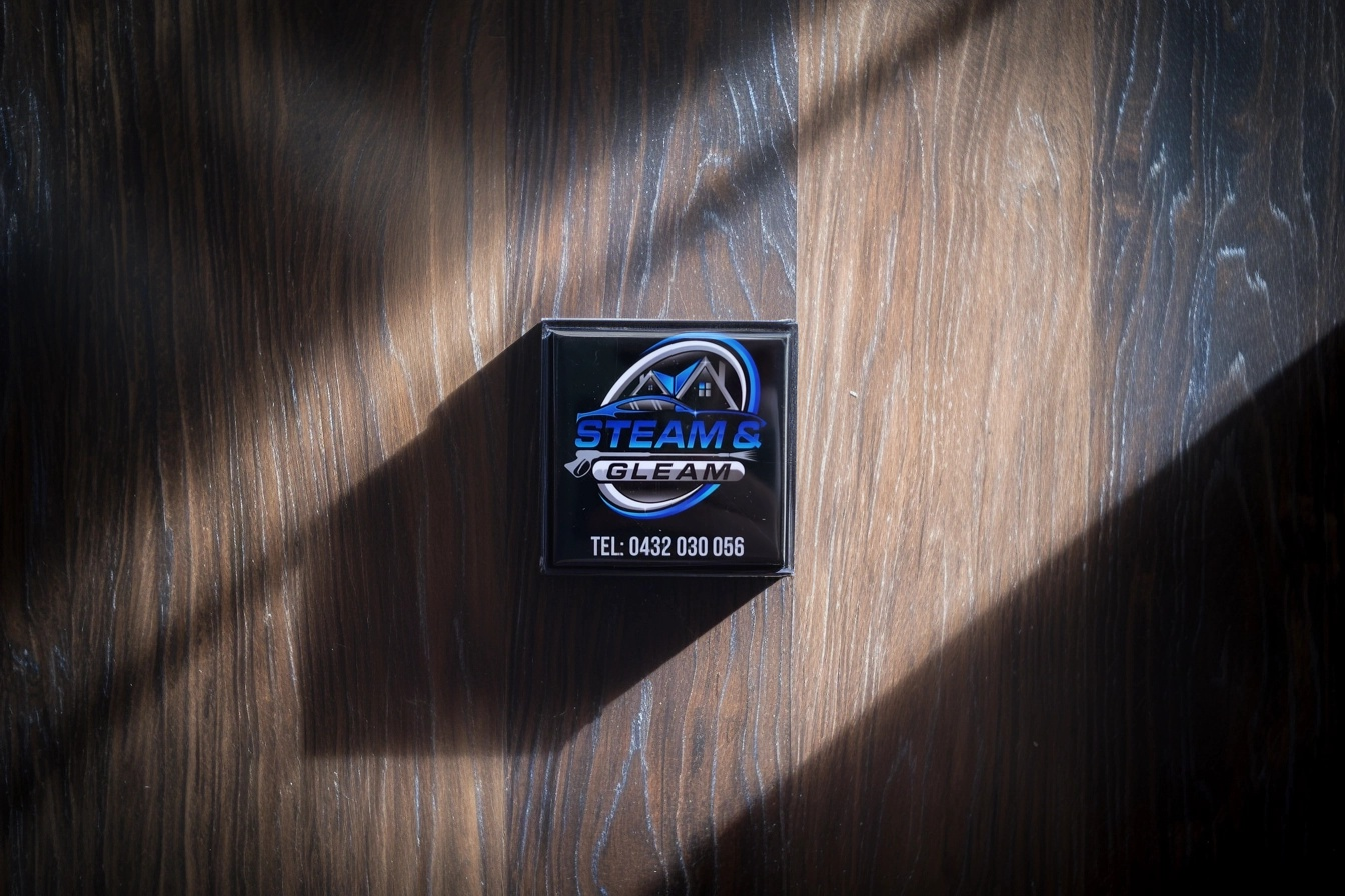 Steam & Gleam branded acrylic magnet on a stylish wooden surface. A sleek, professional photo gift that reflects your brand identity or business image in a modern way