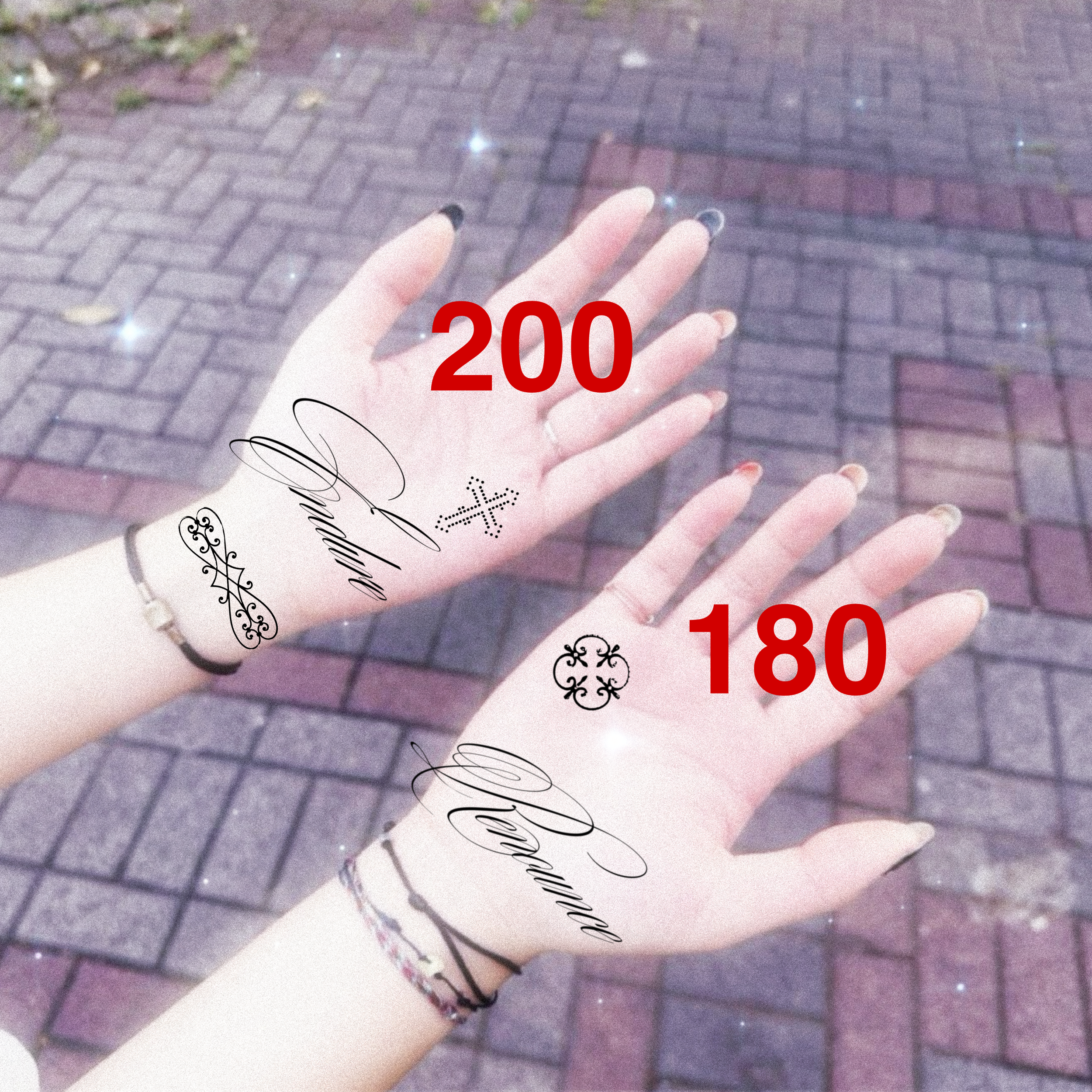 Two outstretched hands with tattoos and rings on fingers, holding or displaying tattoos with the numbers 200 and 180 over a paved sidewalk background.