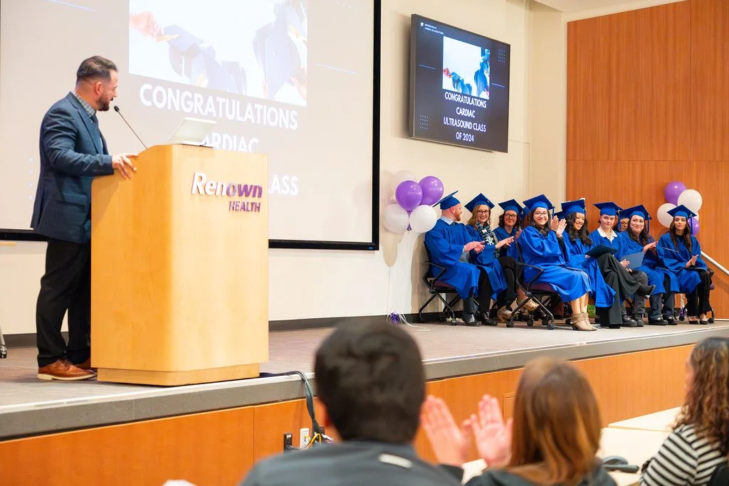 2024 Renown Grad Class Seated With John at Podium.jpg