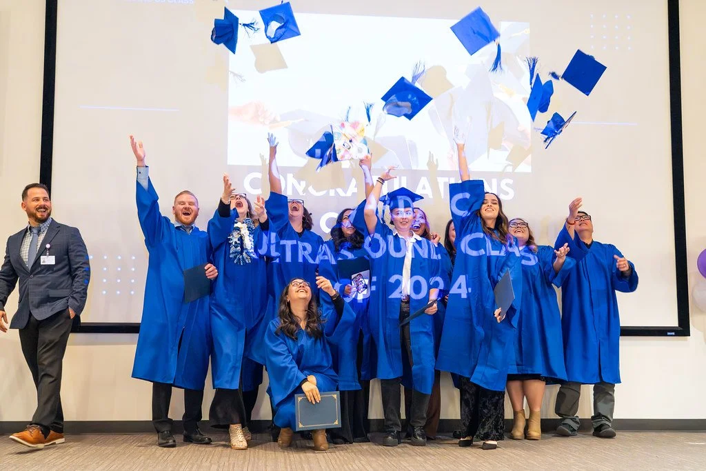 2024 Renown Grad Class With John and Tossing Caps.jpg