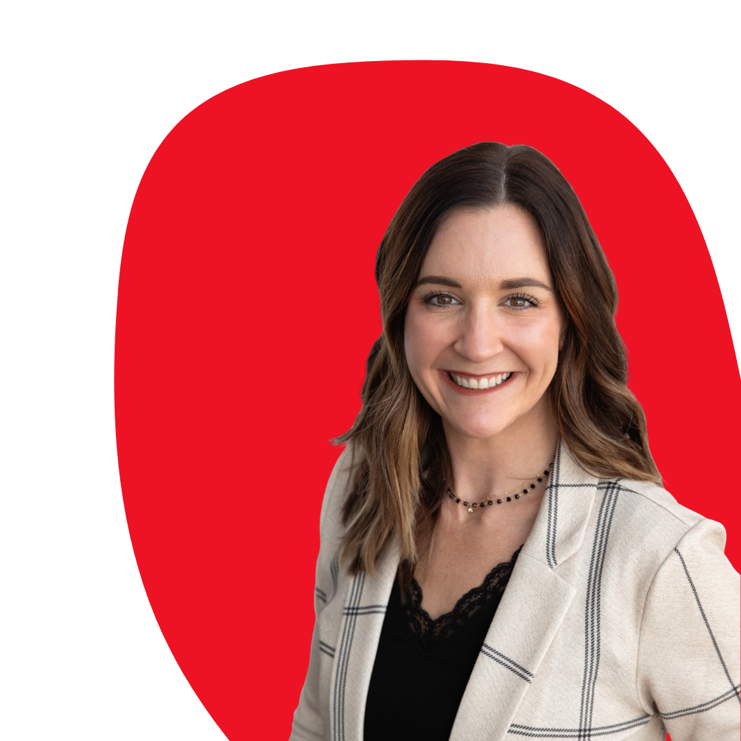 A young woman with shoulder-length brown hair, smiling, wearing a beige blazer with black lines and a black top with lace, against a red background.