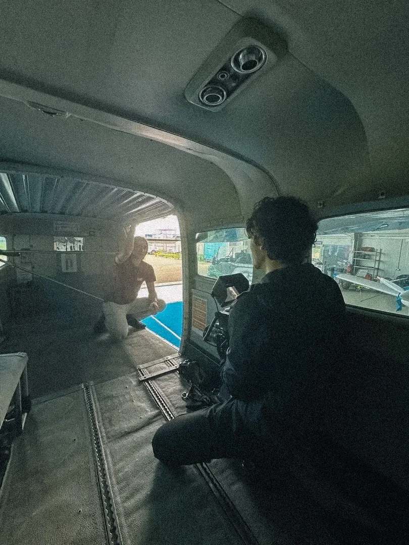 Inside view of a small aircraft with a photographer taking pictures