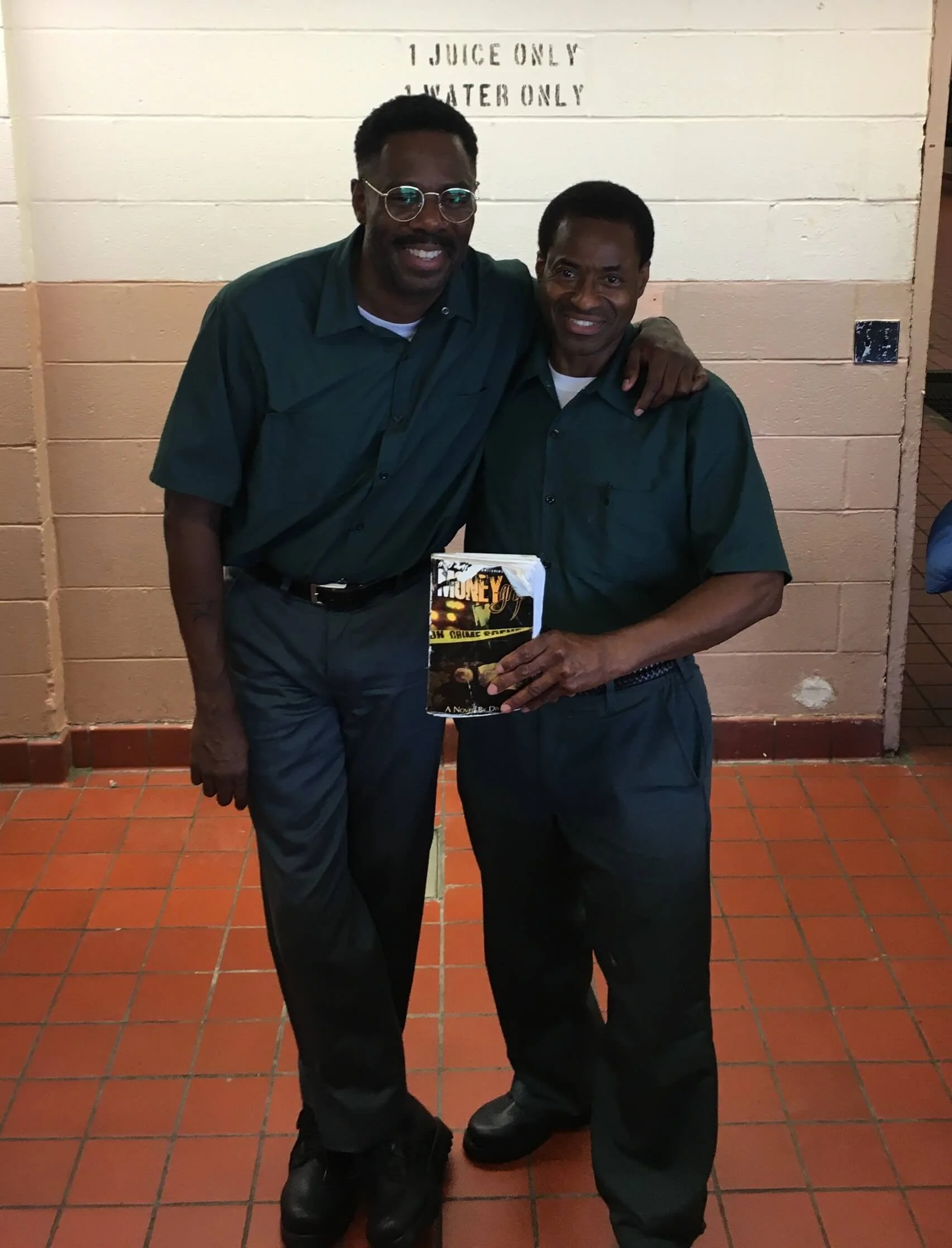 Colman Domingo and Divine G on set, holding the book.