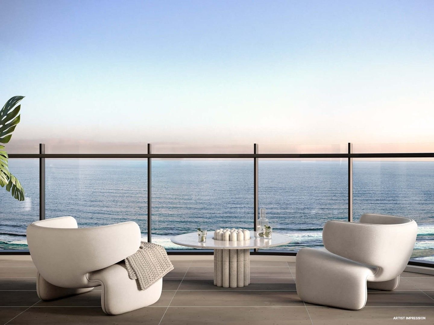 Modern balcony with white designer chairs, round table, ocean view, glass railing, and blue sky.