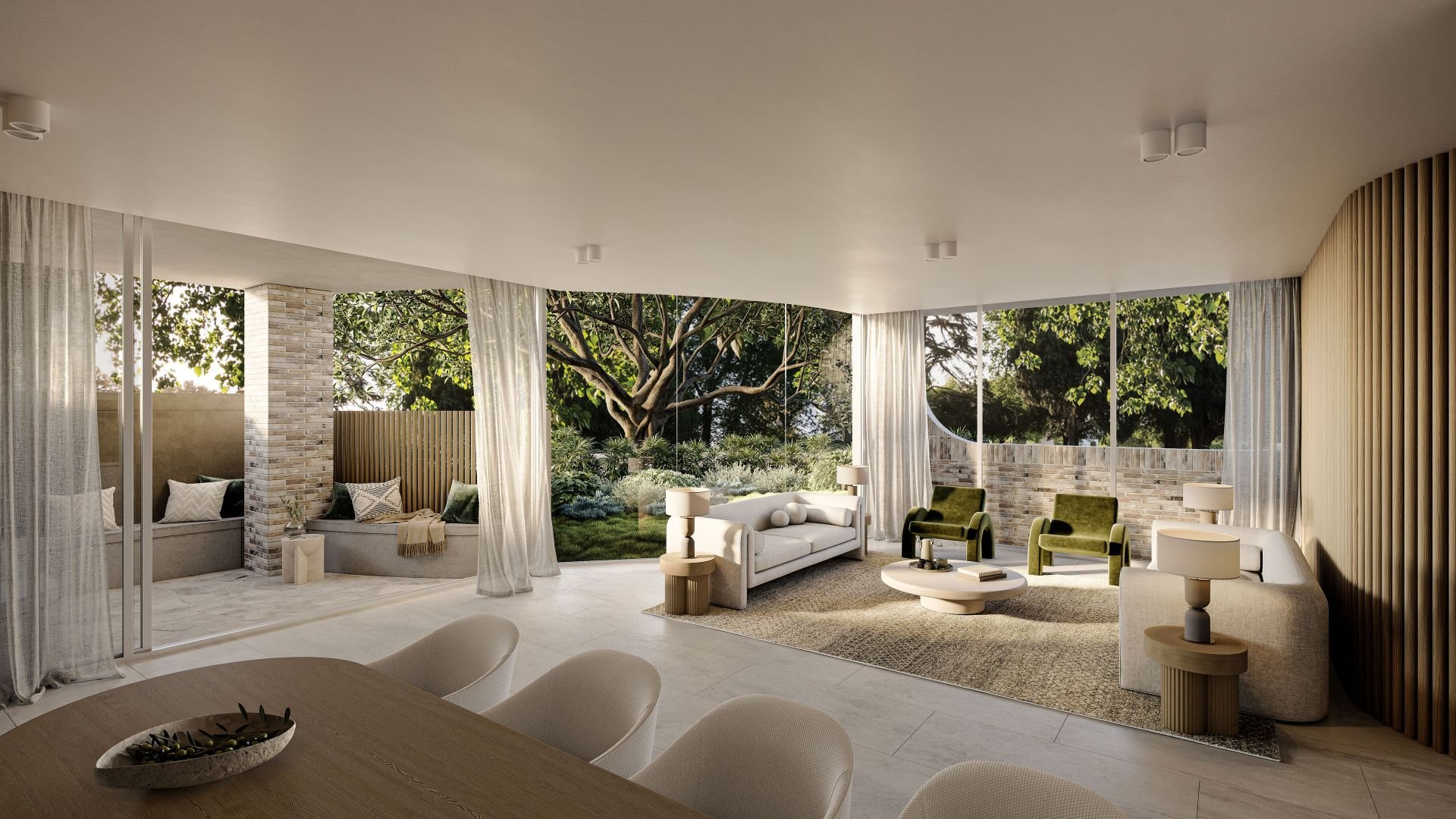Modern living room with large windows, white and green furniture, and a view of a garden with trees.