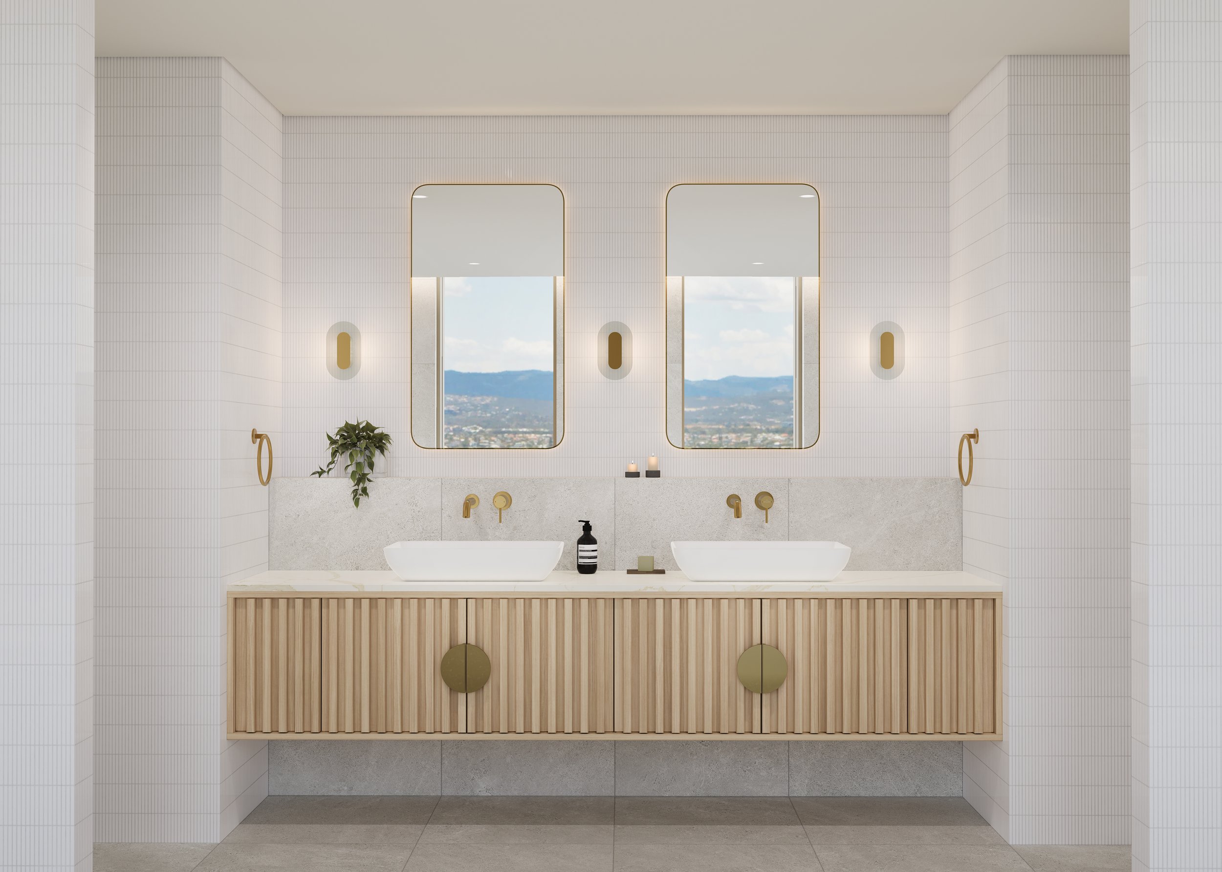 Modern bathroom with double sinks, wooden vanity, gold faucets, two rectangular mirrors, wall sconces, small plants, and mountain view from windows.