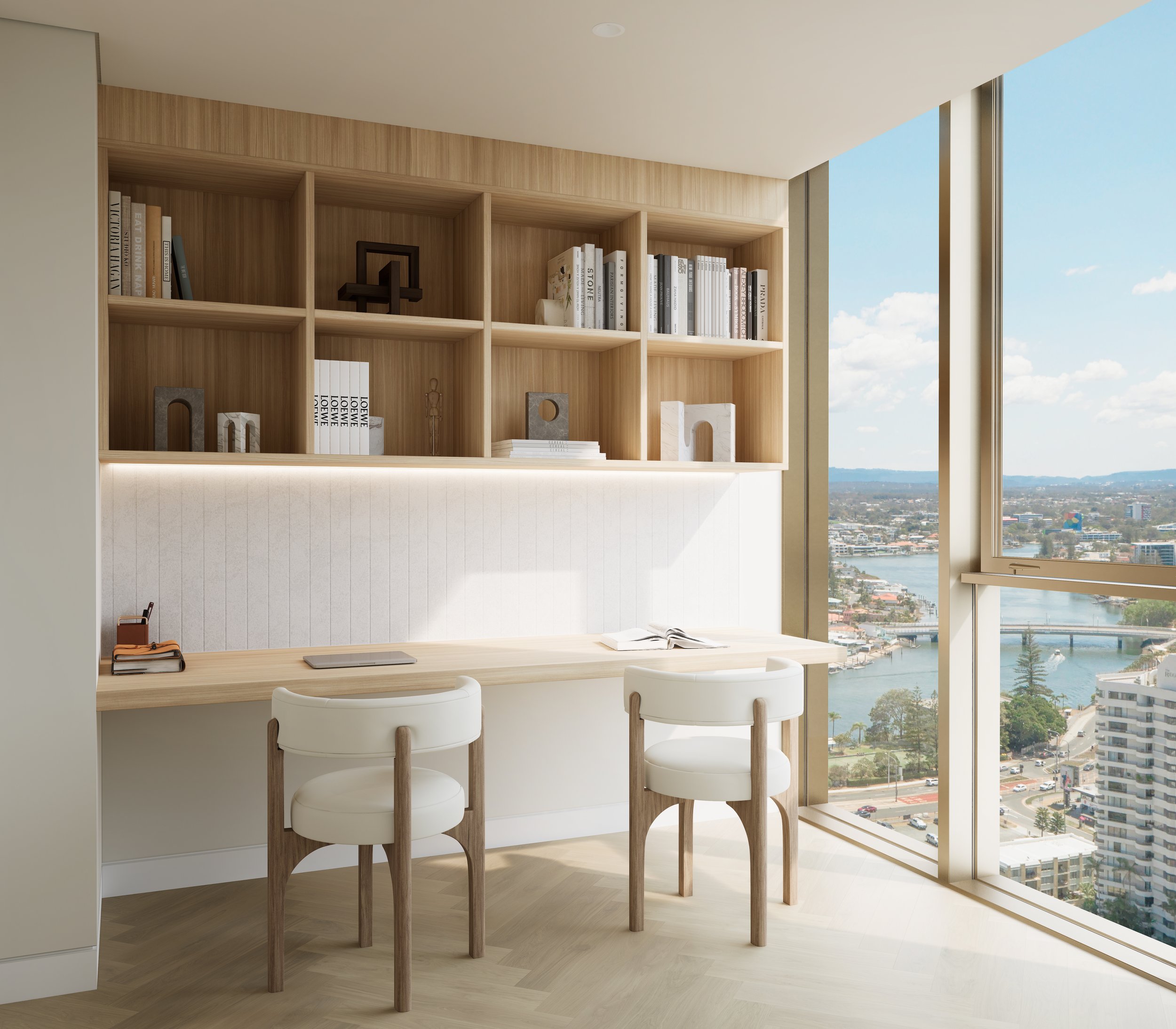 Modern home office with large windows offering a city and river view, featuring a wooden desk, two white chairs, and a wall-mounted bookshelf filled with books and decor.