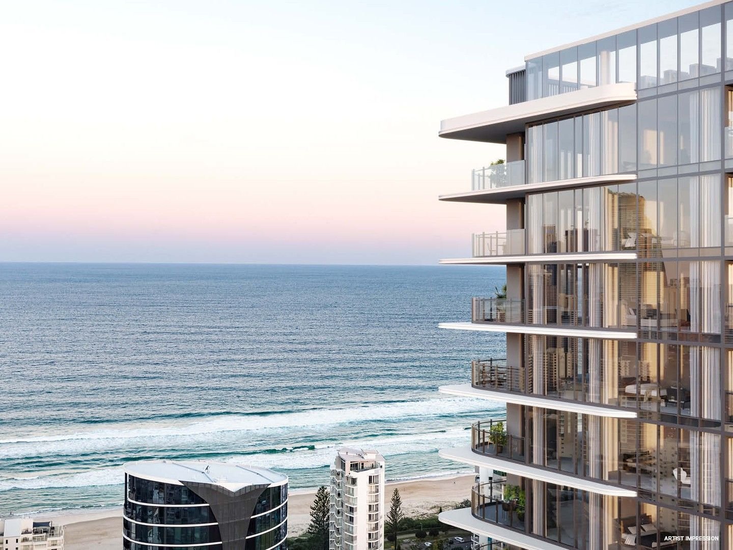 Ocean view with modern beachfront high-rise buildings and balconies during sunset.